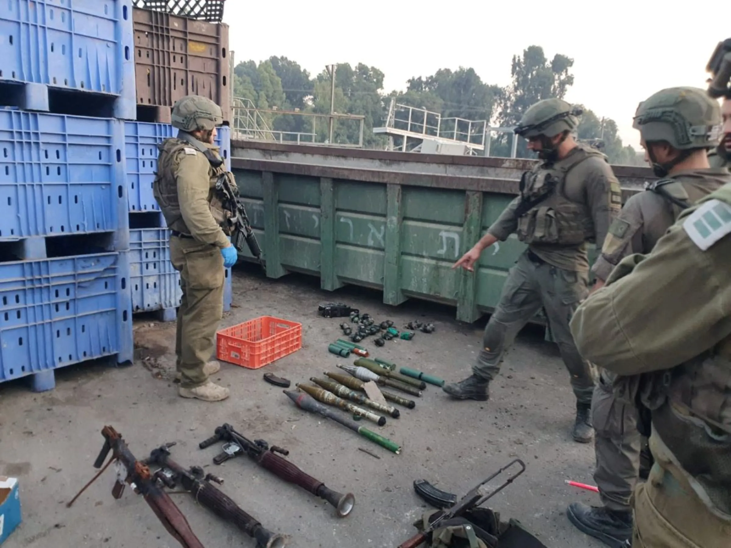 Israeli soldiers stand next to rockets lying on the ground at an unknown location in this social media image released on October 11, 2023. @IDFSpokesperson via X/via REUTERS