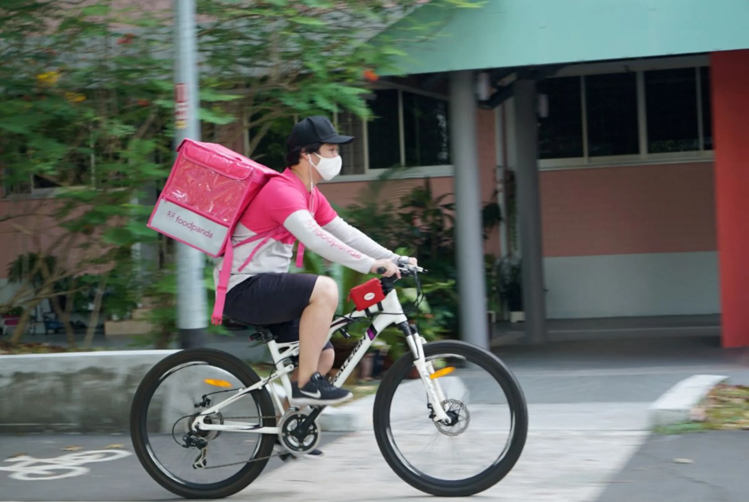 A delivery driver makes a food delivery in Singapore March 9, 2021. REUTERS/Joseph Campbell