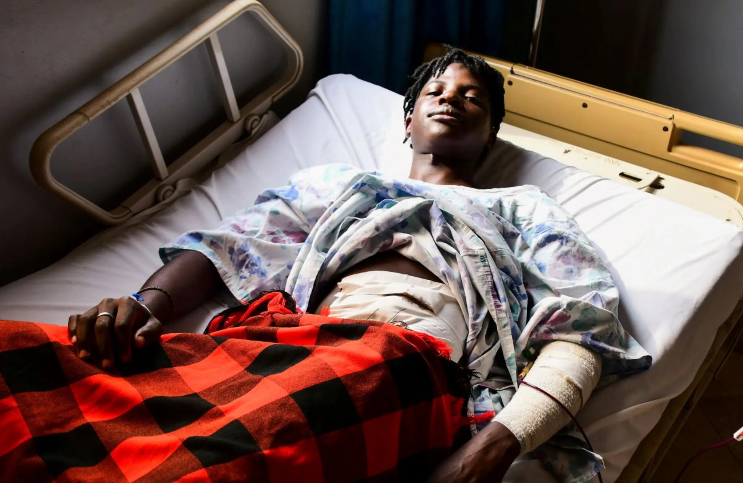 Ugandan LGBTQ activist Steven Kabuye receives treatment after he was attacked and stabbed by unknown people, at a hospital in Kitende along Entebbe road on the outskirts of Kampala, Uganda January 3, 2024. REUTERS/Abubaker Lubowa