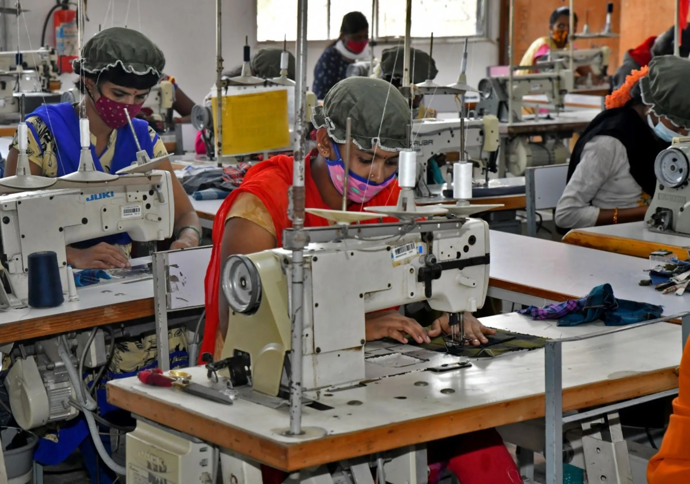 Newly recruited garment workers practice stitching at a textile factory of Texport Industries in Hindupur town in the southern state of Andhra Pradesh, India, February 9, 2022. REUTERS/Samuel Rajkumar