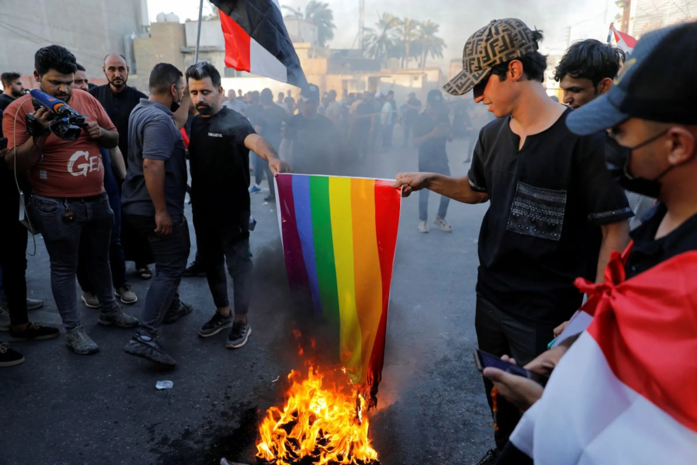 Iraqi demonstrators burn an LGBT flag during a protest in Baghdad, Iraq July 22, 2023. REUTERS/Khalid Al-Mousily