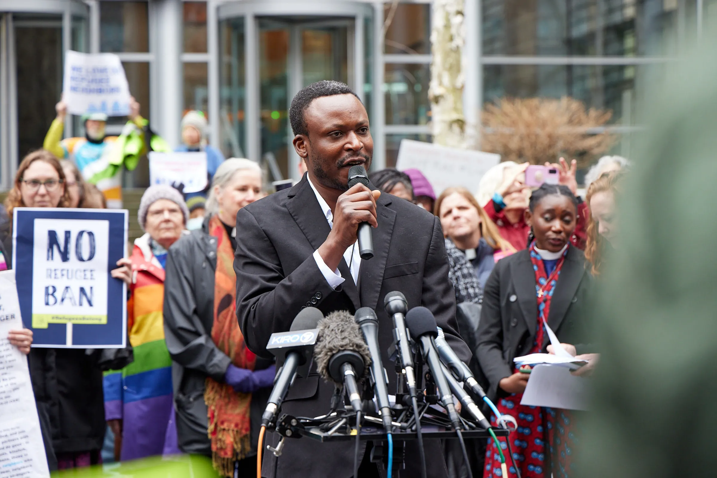 Tshishiku Henry addresses a February 25 rally outside a Seattle courthouse on a lawsuit over the federal government’s halting the U.S. refugee program. Stewart Tilger/International Refugee Assistance Project/Handout via Thomson Reuters Foundation