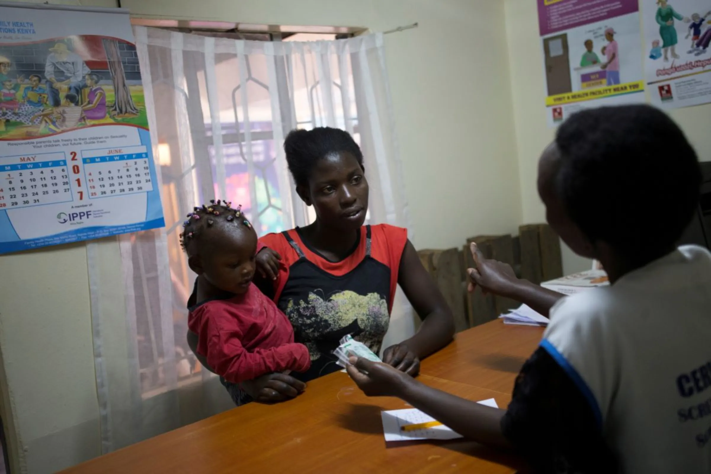A patient talks to a health worker at a Family Health Options clinic in the Kibera slums in Nairobi, Kenya, May 16, 2017. REUTERS/Baz Ratner