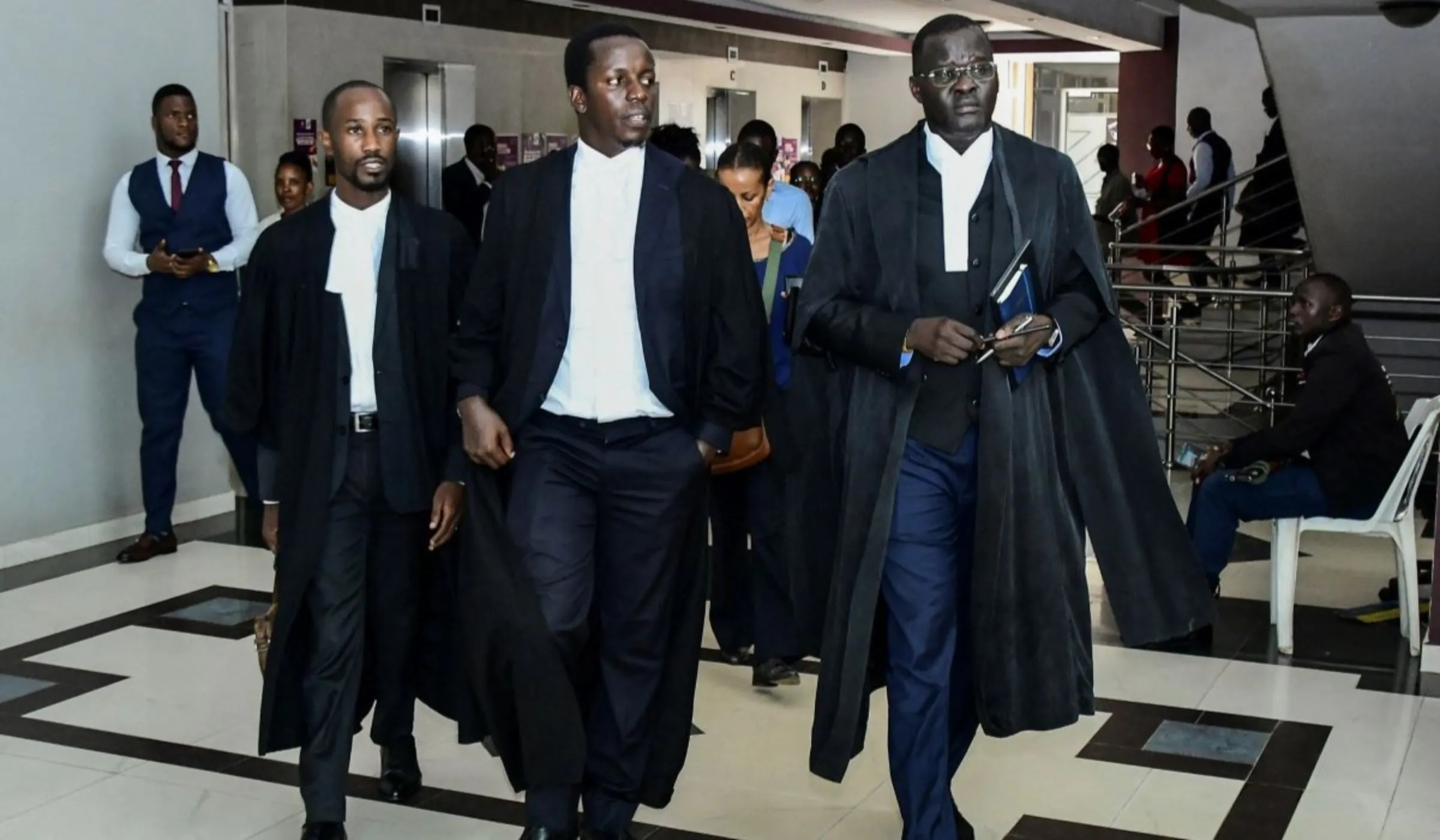 Human Rights Lawyers for the petitioners Henry Byansi, Derrick Tukwasiibwe and Nicholas Opiyo leave the Constitutional Court, after the Court upheld the anti-LGBTQ Law in Kampala, Uganda April 3, 2024. REUTERS/Abubaker Lubowa