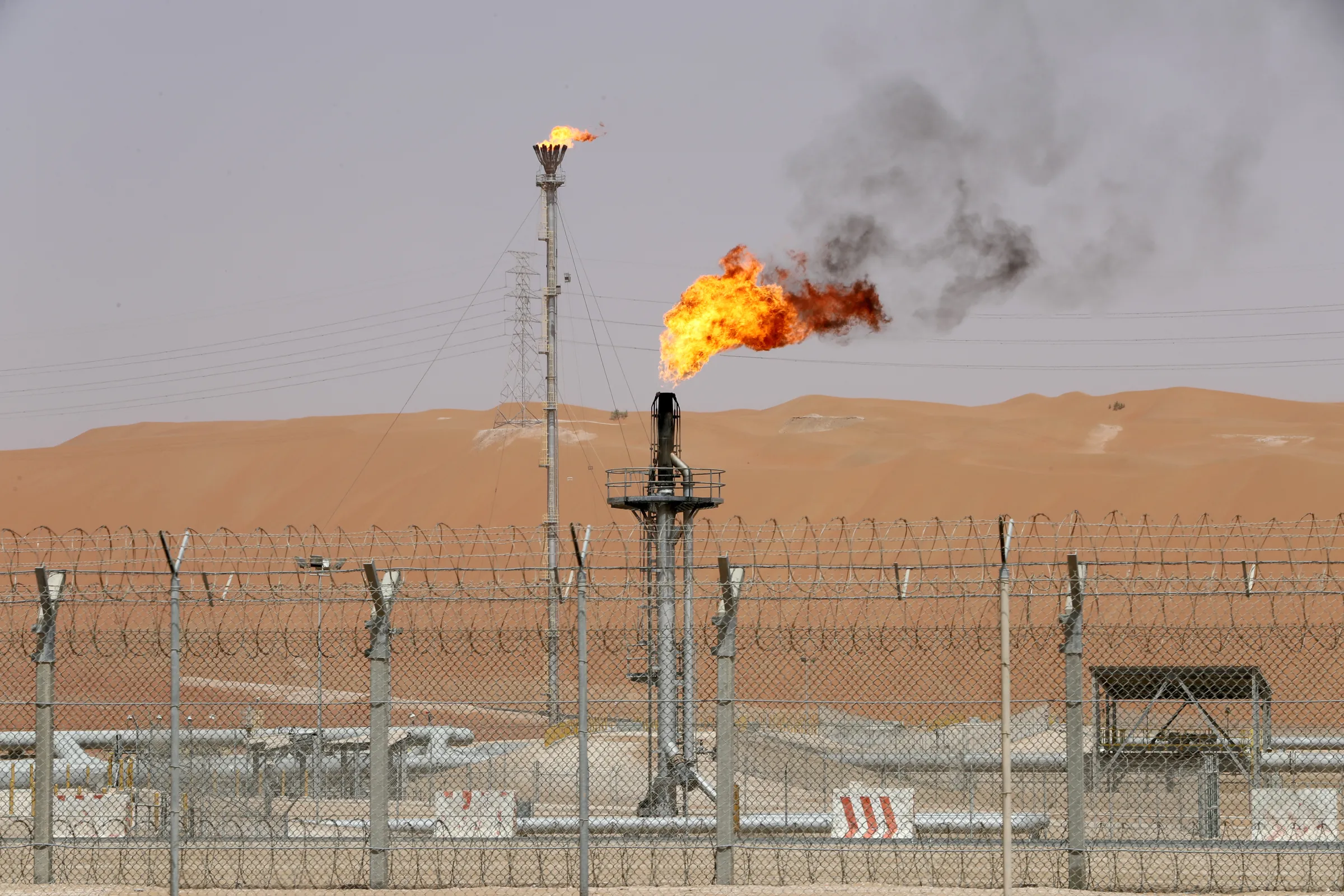 Flames are seen at the production facility of Saudi Aramco's Shaybah oilfield in the Empty Quarter, Saudi Arabia May 22, 2018. REUTERS/Ahmed Jadallah