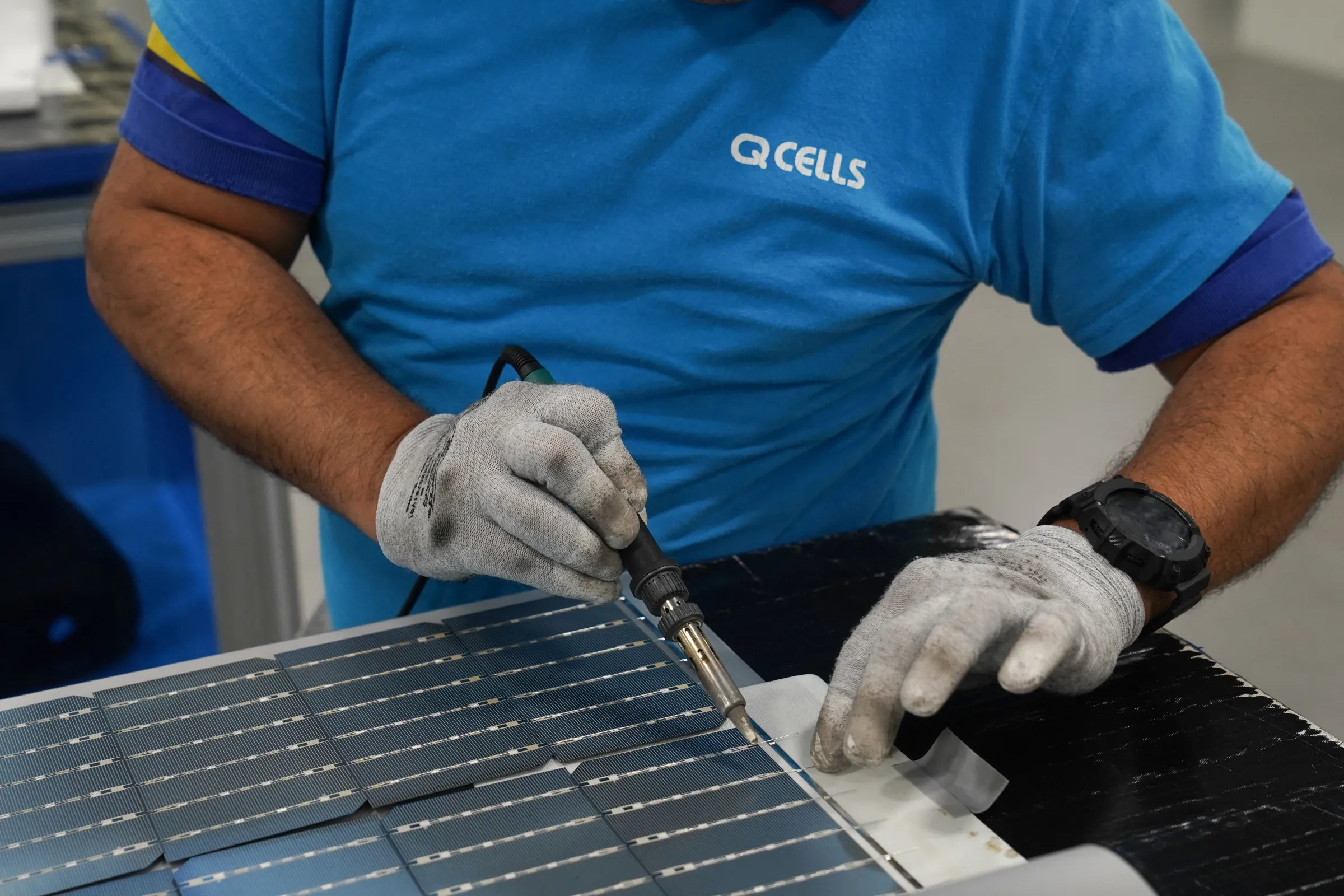 An employee works on solar panels at the QCells solar energy manufacturing factory in Dalton, Georgia, U.S., March 2, 2023. REUTERS/Megan Varner