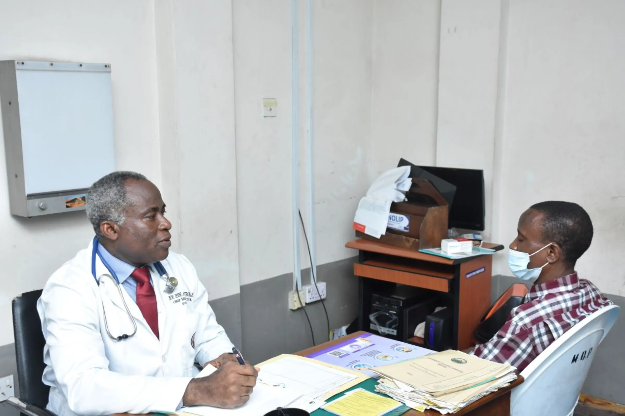 Chief Medical Director, University Teaching College Hospital, Ibadan in Nigeria, Prof. Jesse Omotegbayo seen speaking to a patient. Bukola Adebayo/Thomson Reuters Foundation.