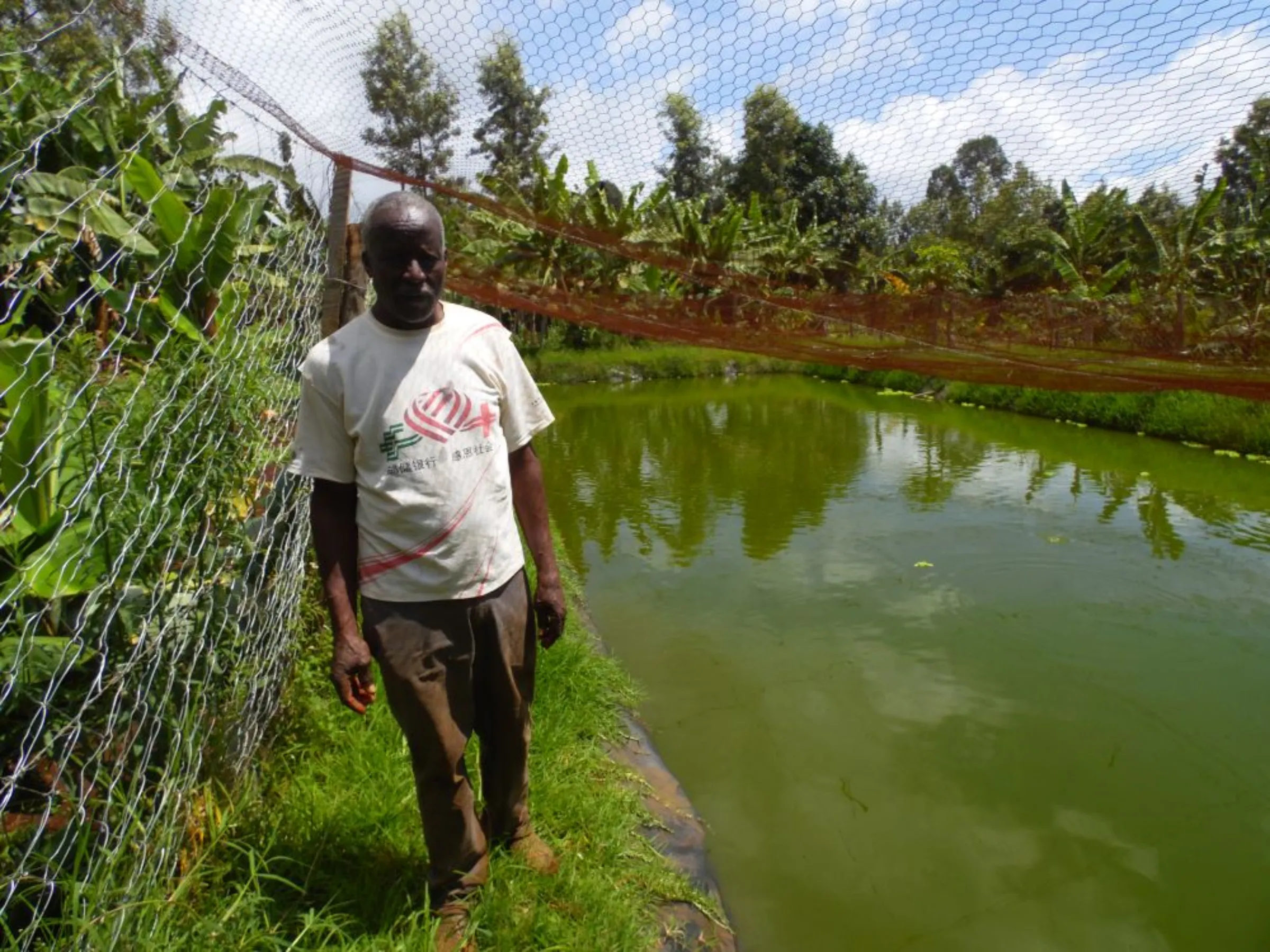 Elijah Murithi poses for a photo in his coffee plantation in Kibingo, central Kenya, 7 December 2022