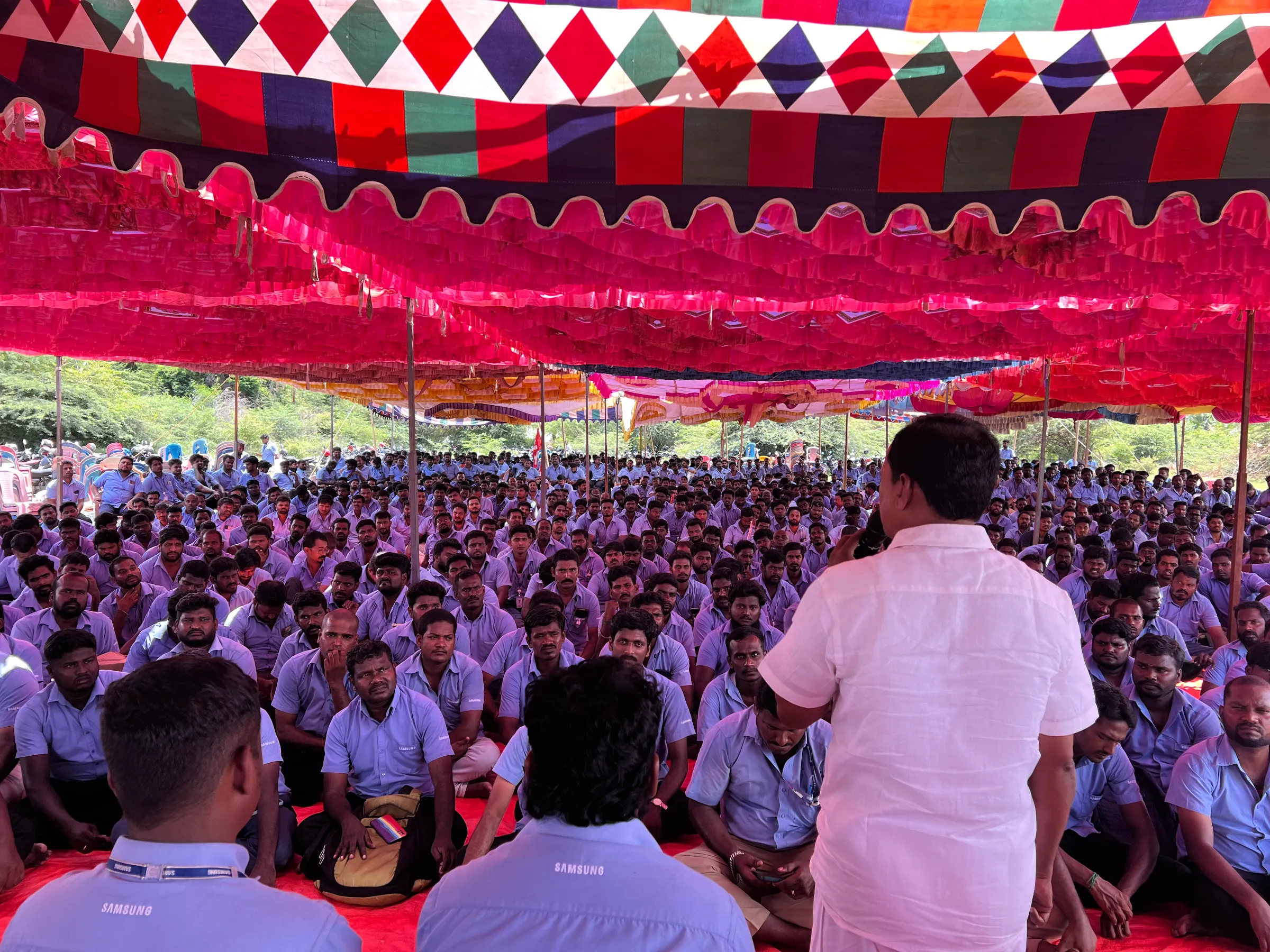 Workers of a Samsung facility listen to a speaker during a strike to demand higher wages at its Sriperumbudur plant near the city of Chennai, India, September 30, 2024. Thomson Reuters Foundation/Greeshma Kuthar