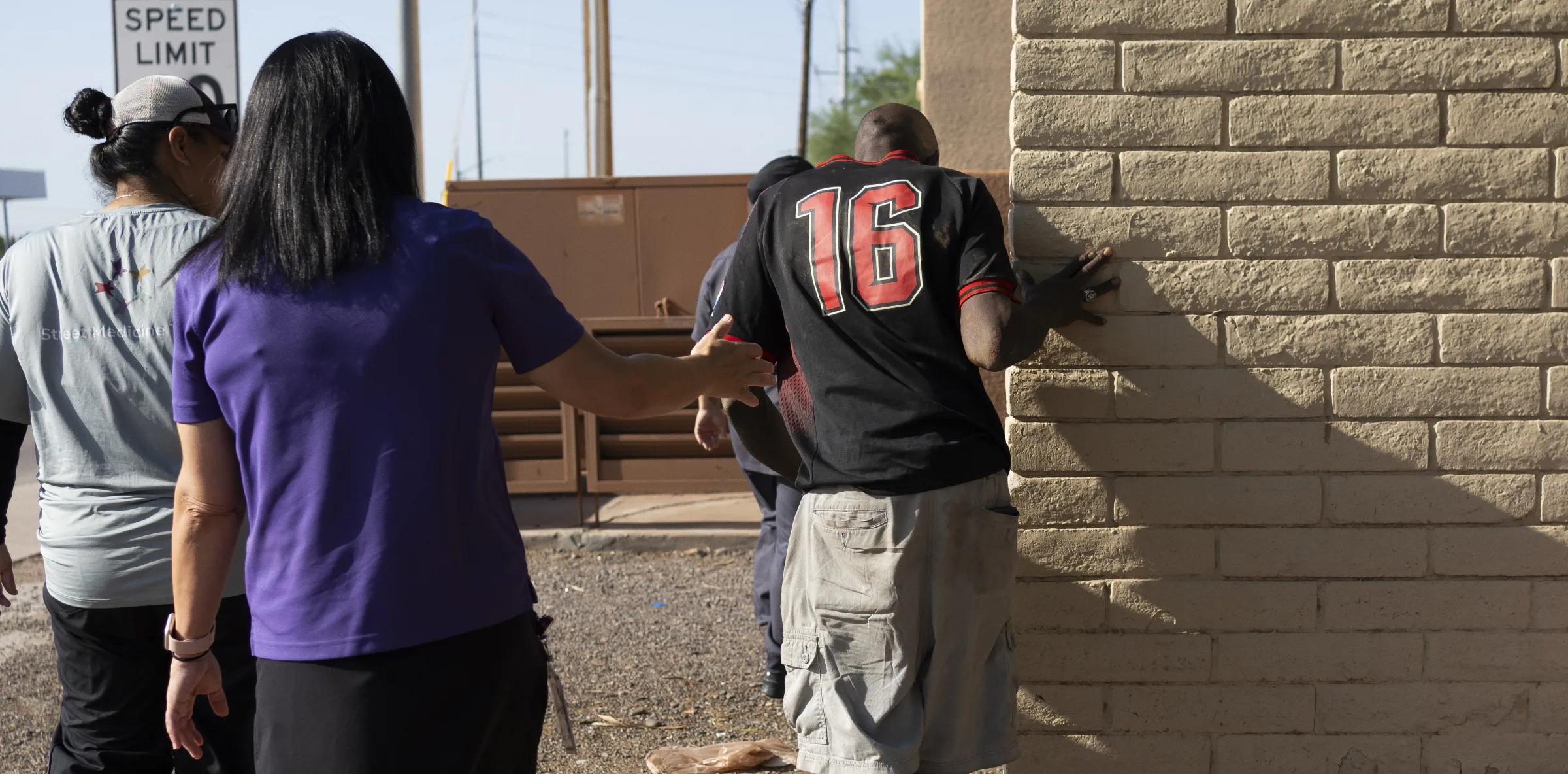 Circle the City staff Brenda Madril, left, and Liz Smith, center left, assist Tyrone James to their van to receive medical care. July 15, 2024. Thomson Reuters Foundation/Rebecca Noble