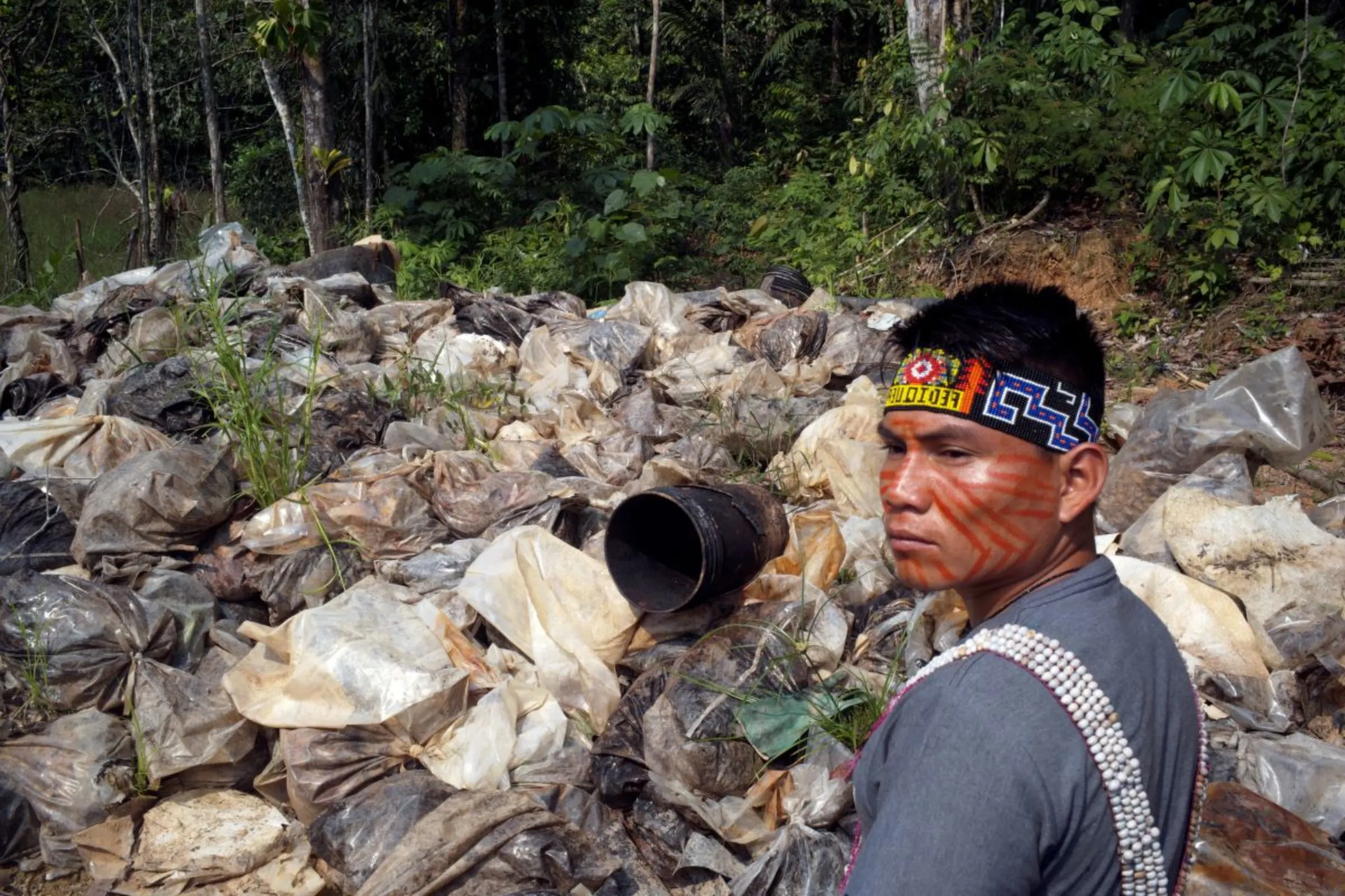 A community leader shows plastic bags filled with contamination cleaned from oil spills in Block 192, a dormant Amazon field with a history of environmental spills where Peru is looking to reboot production amid soaring global crude prices linked to Russia's invasion of Ukraine, near Nuevo Andoas, Peru February 21, 2022. REUTERS/Alessandro Cinque