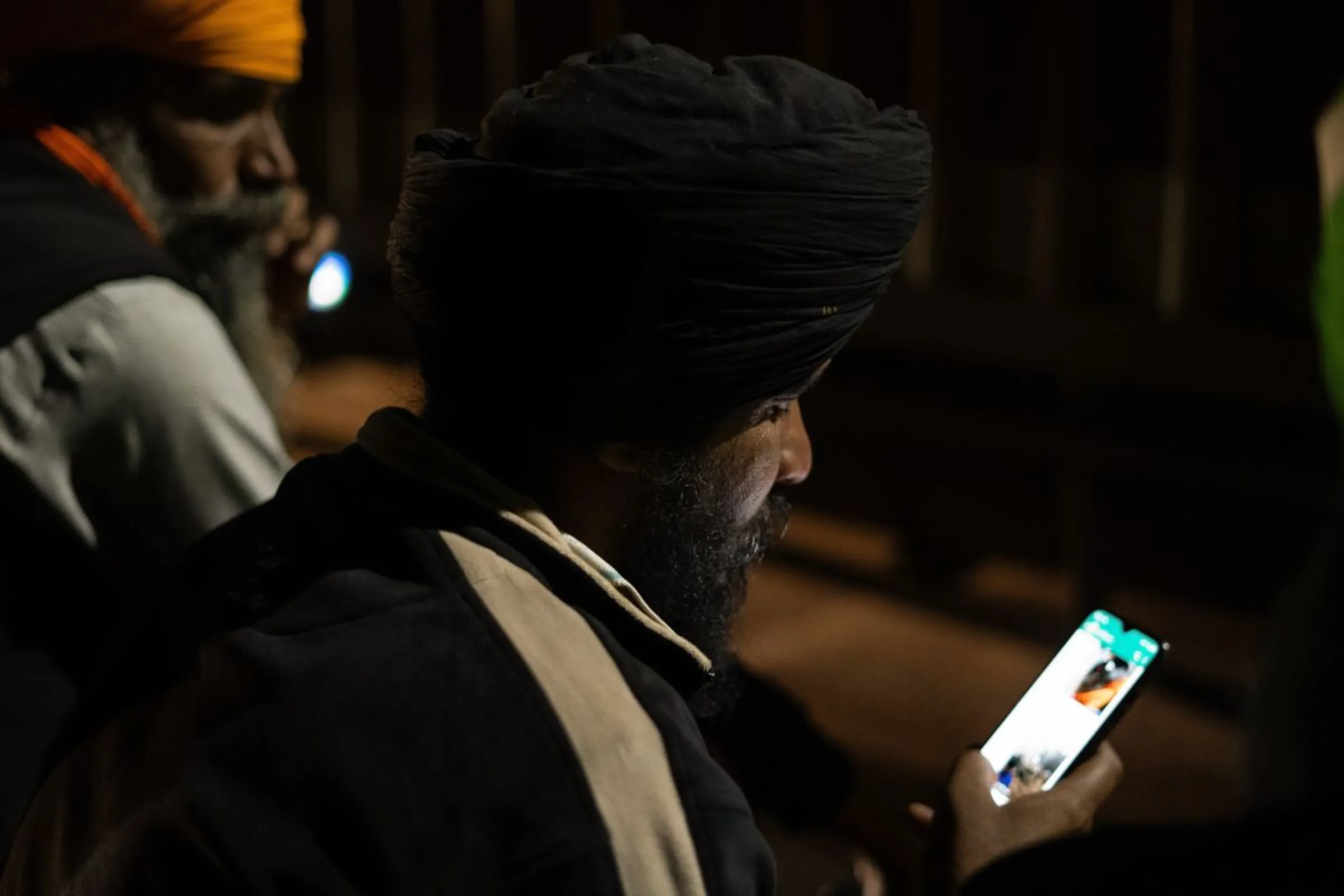 A protester attempts to access the internet on his mobile phone near Shambhu Barrier, India, February 21, 2024. Thomson Reuters Foundation/Abrar Fayaz