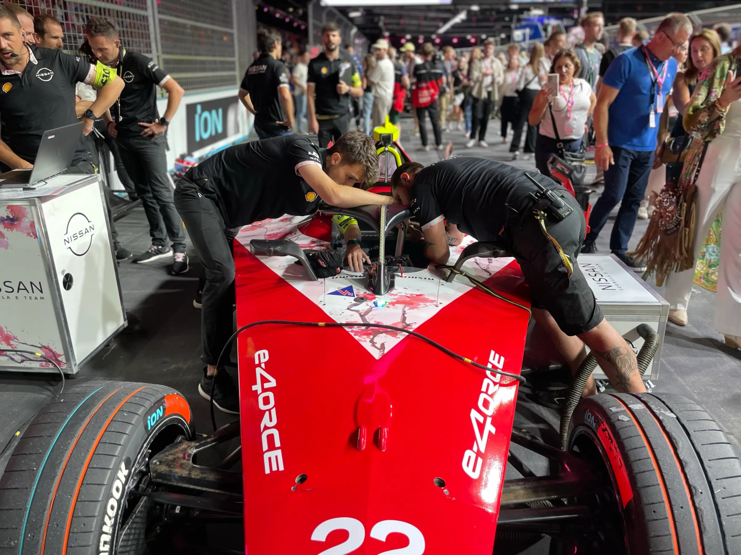 Members of the Nissan Formula E team make final adjustments to the Nissan e-4ORCE 04 race car before round 15 of the Formula E world championship at the ExCeL Centre in London, July 20, 2024.