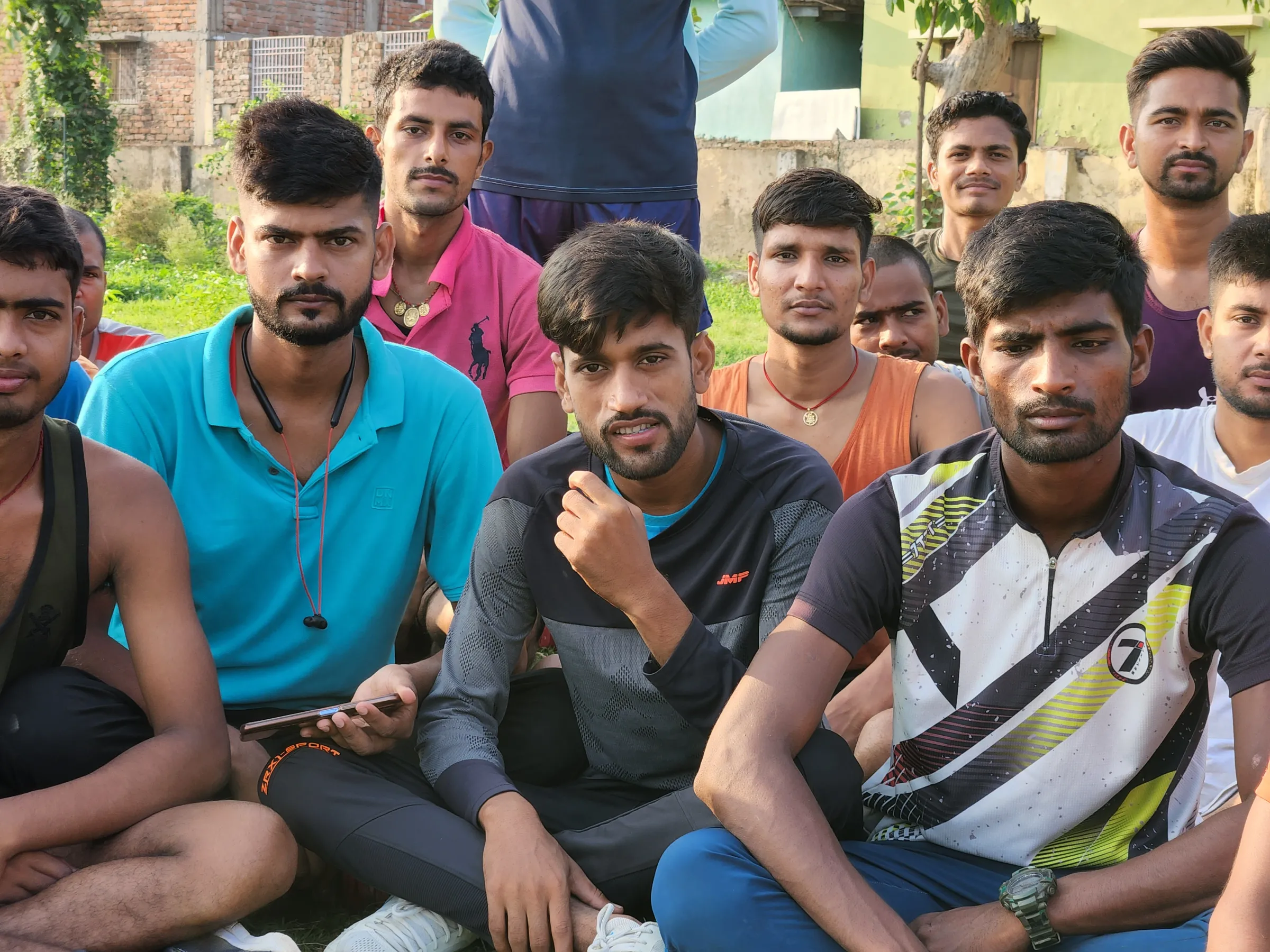 Young army aspirants Neeraj Kumar and Ravi Ranjan Rai (C) pose for with their classmates for a photo