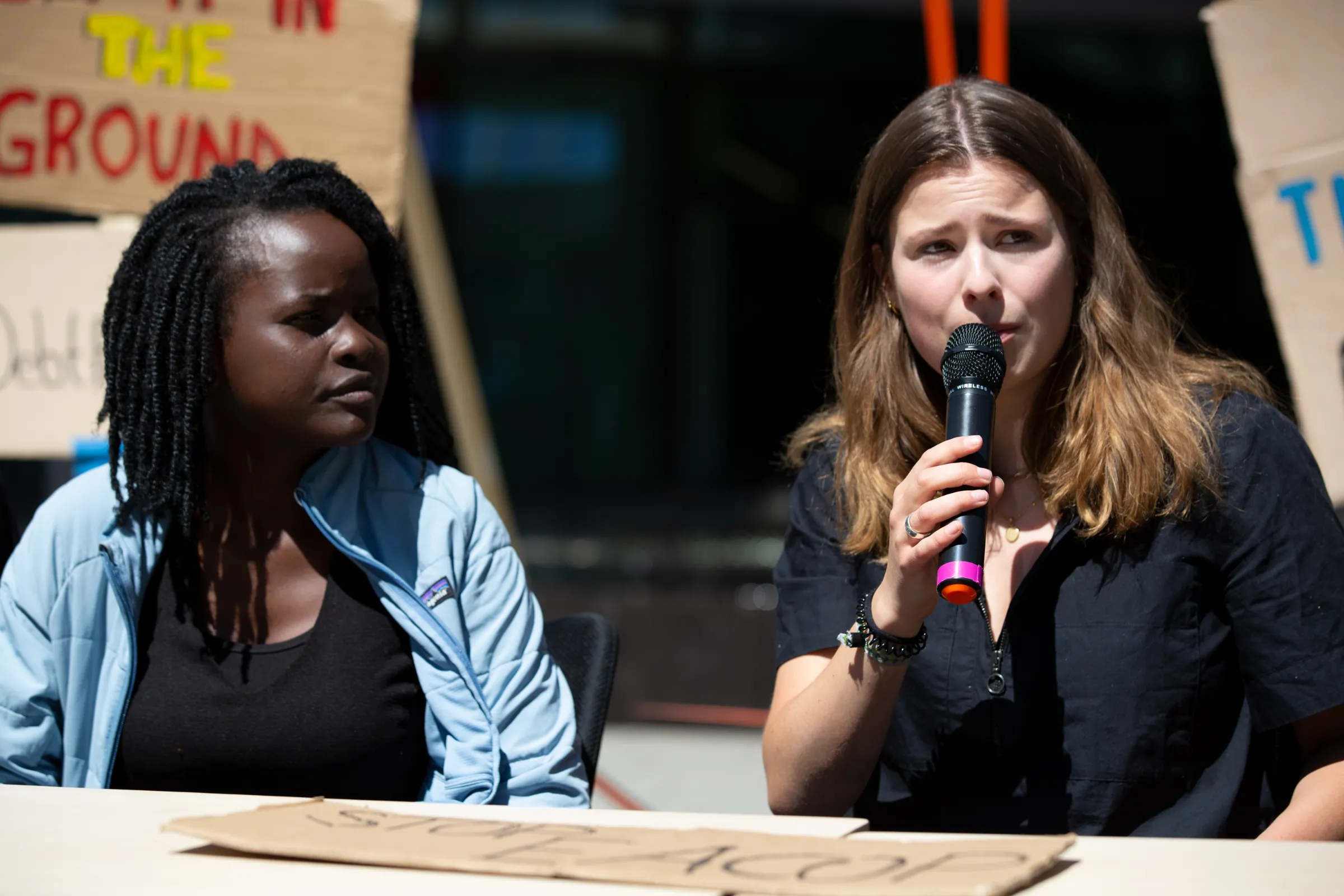 Youth activists Evelyn Ocham and Luisa Neubauer hold a press conference outside Deutsche Bank in Frankfurt after meeting CEO Christian Sewing. June 28, 2022. Hosam Katan/Handout via Thomson Reuters Foundation