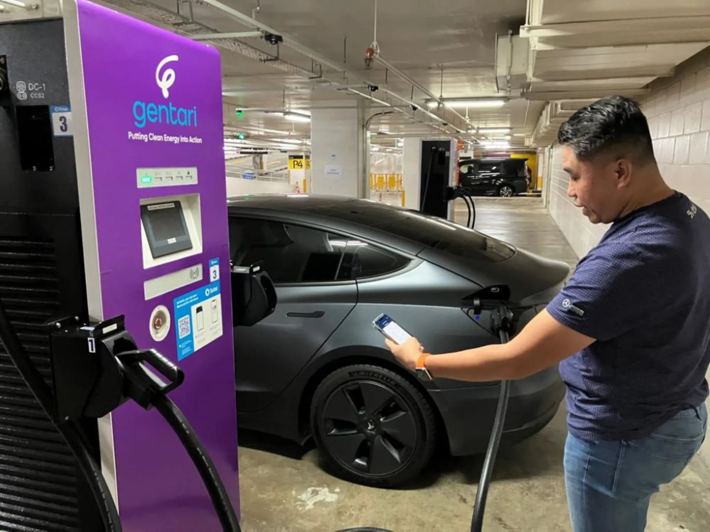 Malaysian Farhan Abdul Rahim charges his Tesla electric car in the car park under the iconic Petronas Twin Towers in Kuala Lumpur, Malaysia on Feb 15, 2023