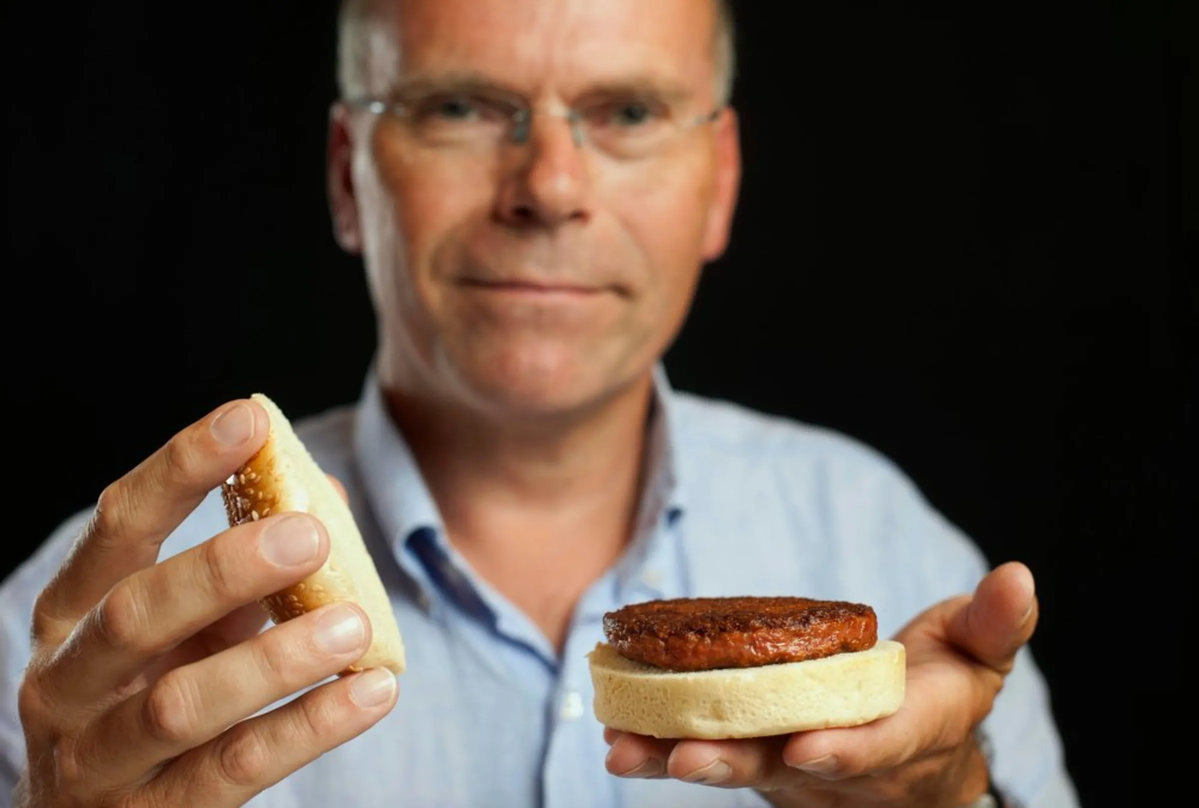 Professor Mark Post shows the world's first lab-grown beef burger during a launch event in west London August 5, 2013