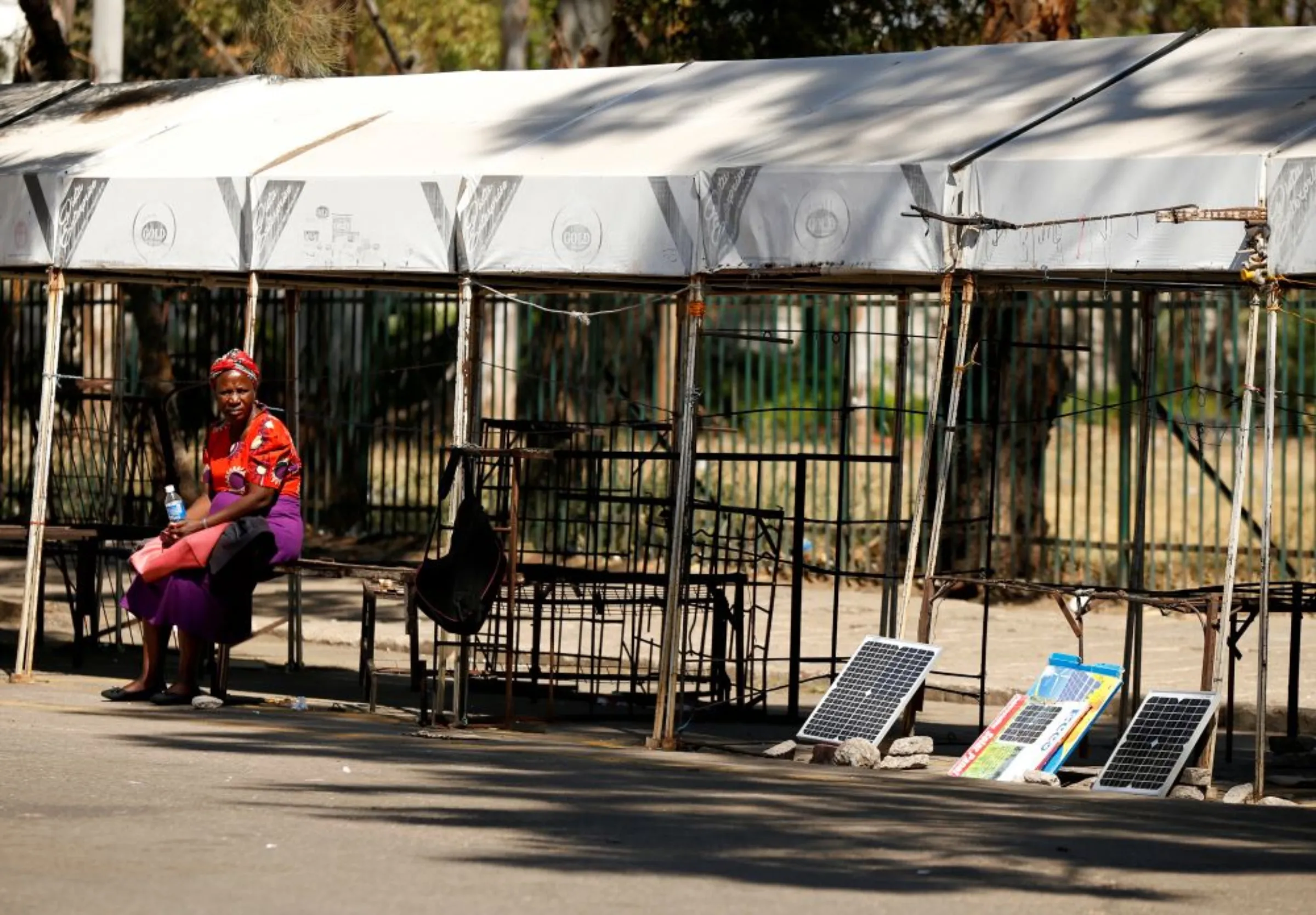 A solar panel vendor waits for clients at a market, after Zimbabwe police banned an anti-government demonstration in Bulawayo, Zimbabwe, August 19, 2019