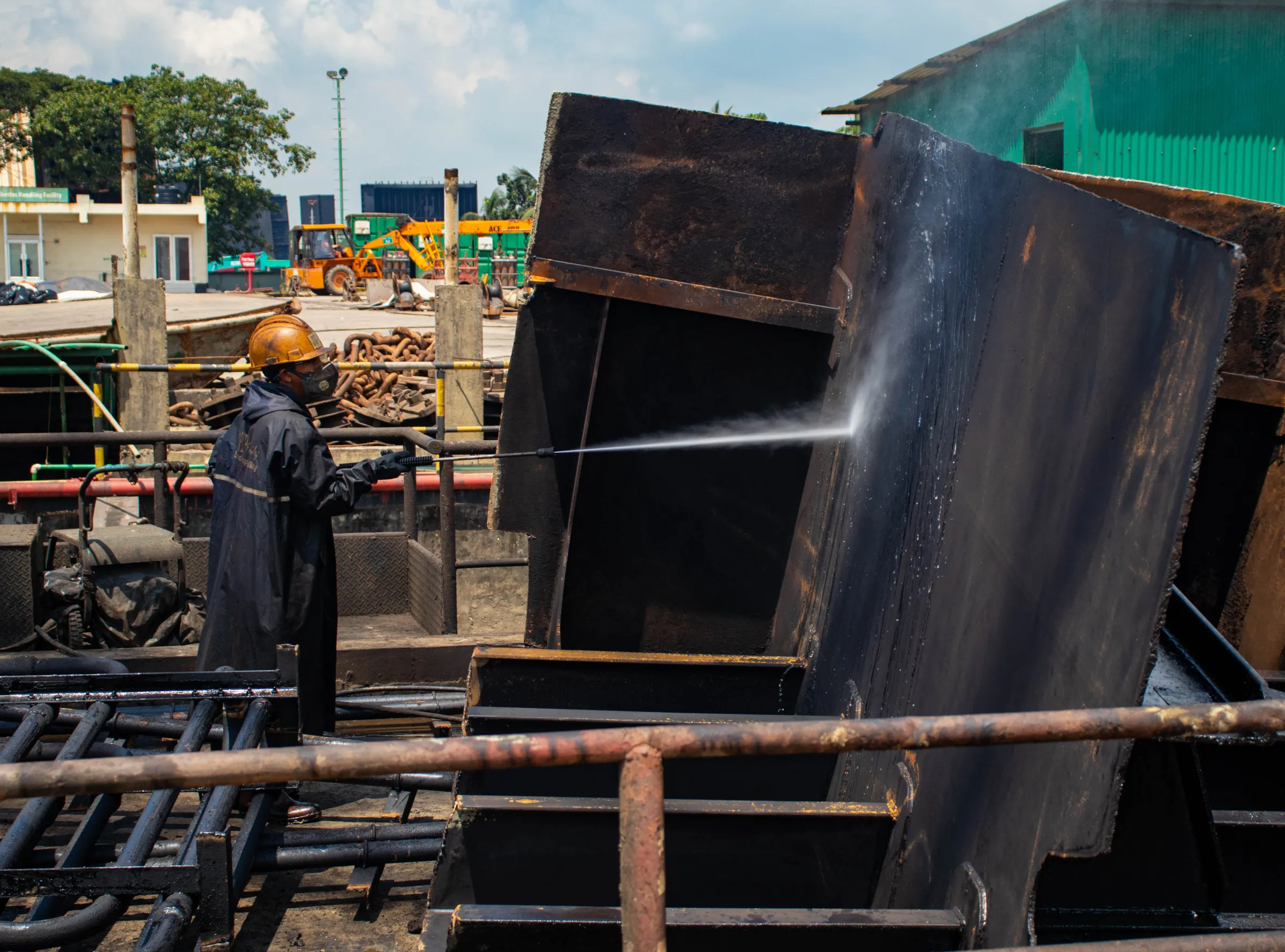 A worker washes a block of steel cut out from a ship at the PHP Shipbreaking yard in Chattogram, Bangladesh on September 23, 2021