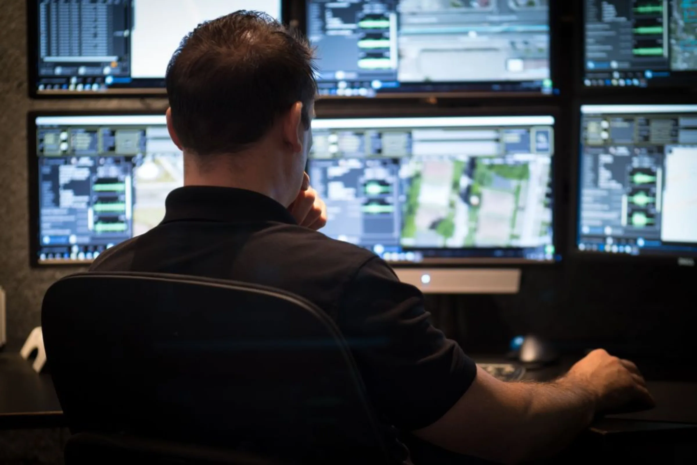 A man works at a computer with several screens reviewing ShotSpotter alerts at a center in California in 2017. ShotSpotter/Handout via Thomson Reuters Foundation.