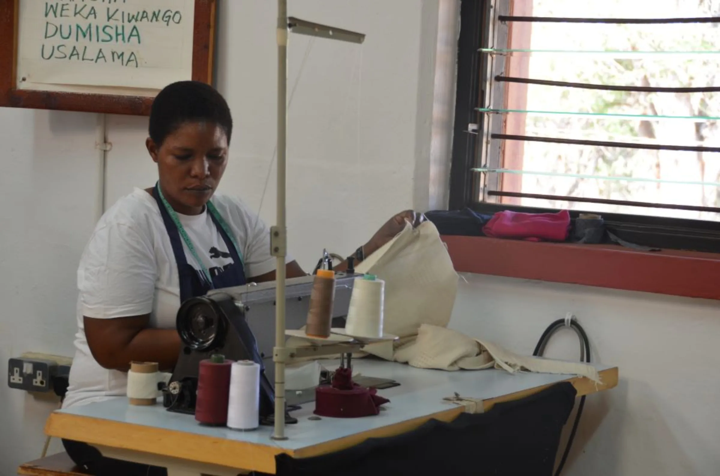 A woman working at the Wildlife Works garment factory inside the Kasigau Redd+ project in Kenya. February 2023