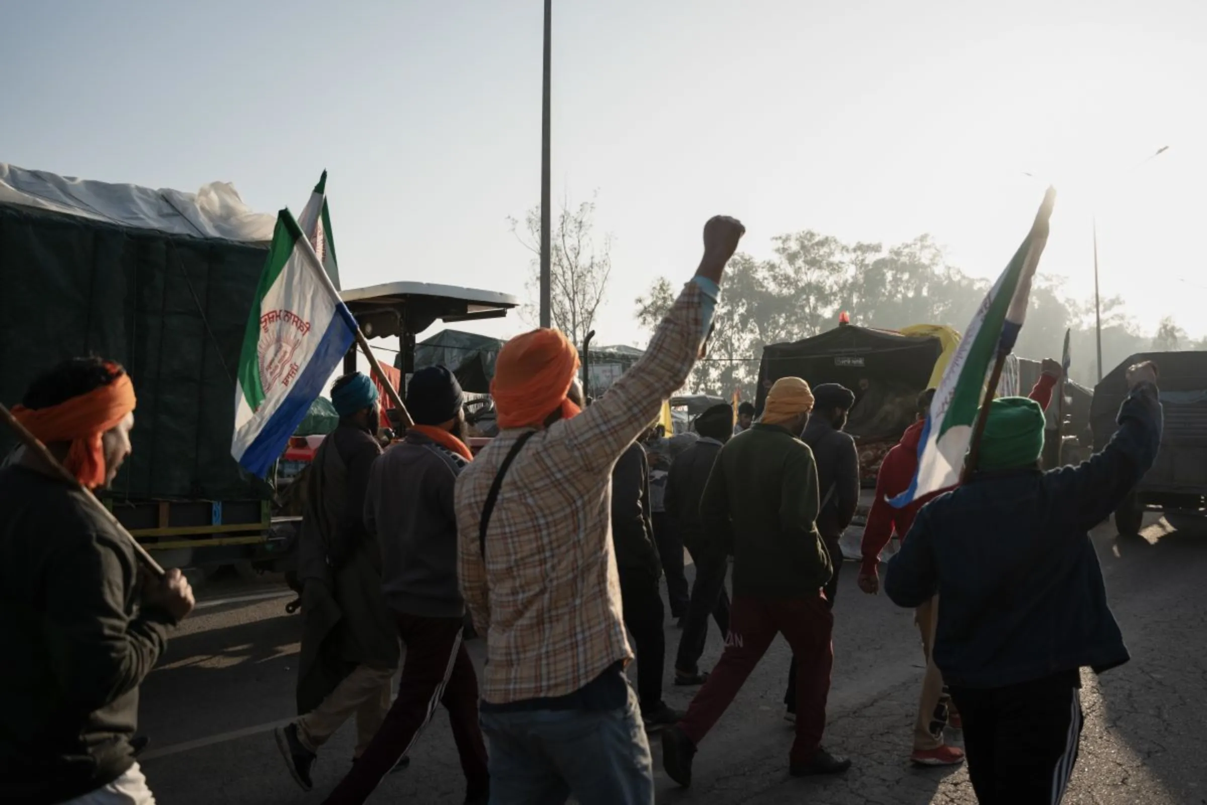 A group of farmers chant slogans and wave flags as they march at Shambhu Barrier, India, February 21, 2024. Thomson Reuters Foundation/Mehran Firdous