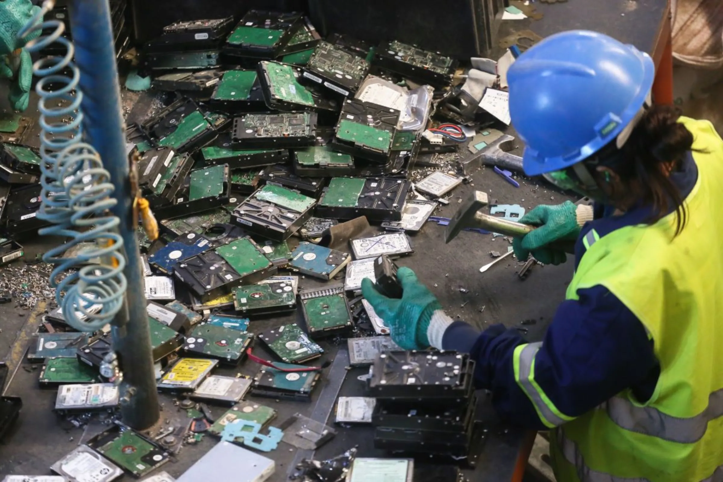 A worker at a landfill in Caieiras picks through tech garbage for precious minerals, in Caieiras, Brazil, July 22, 2022