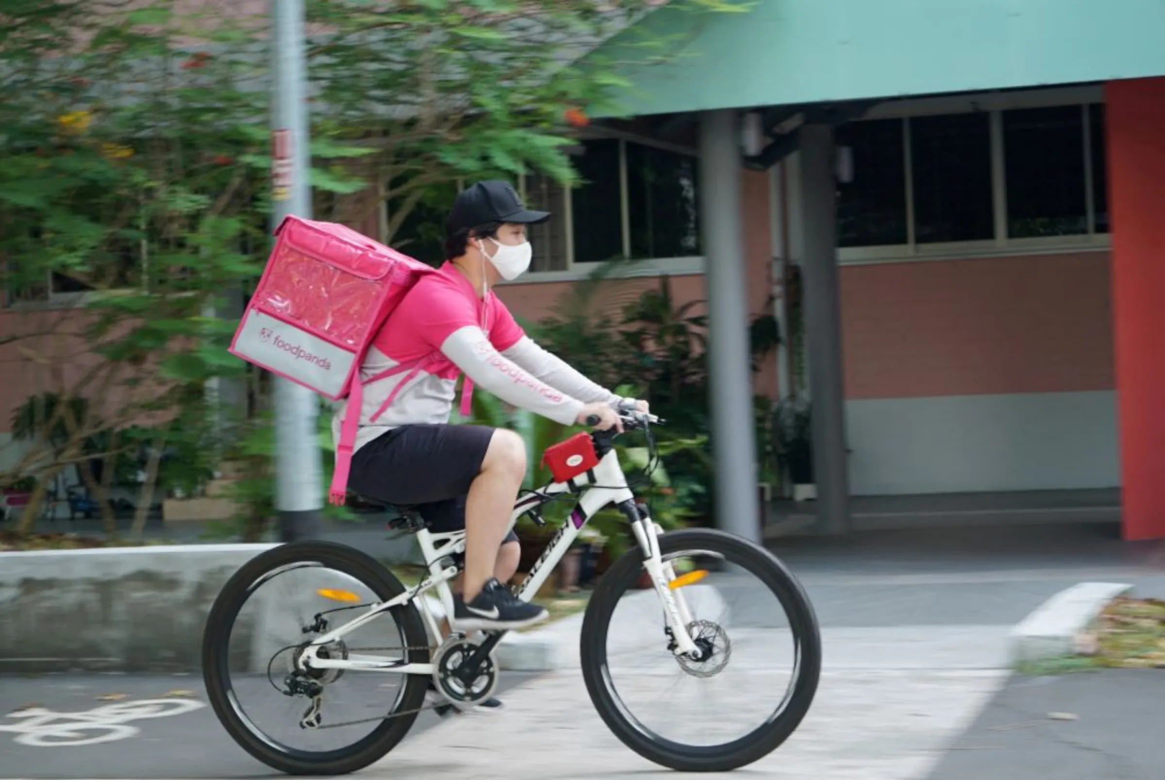 A delivery driver makes a food delivery, amid the coronavirus disease (COVID-19) outbreak, in Singapore March 9, 2021. REUTERS/Joseph Campbell