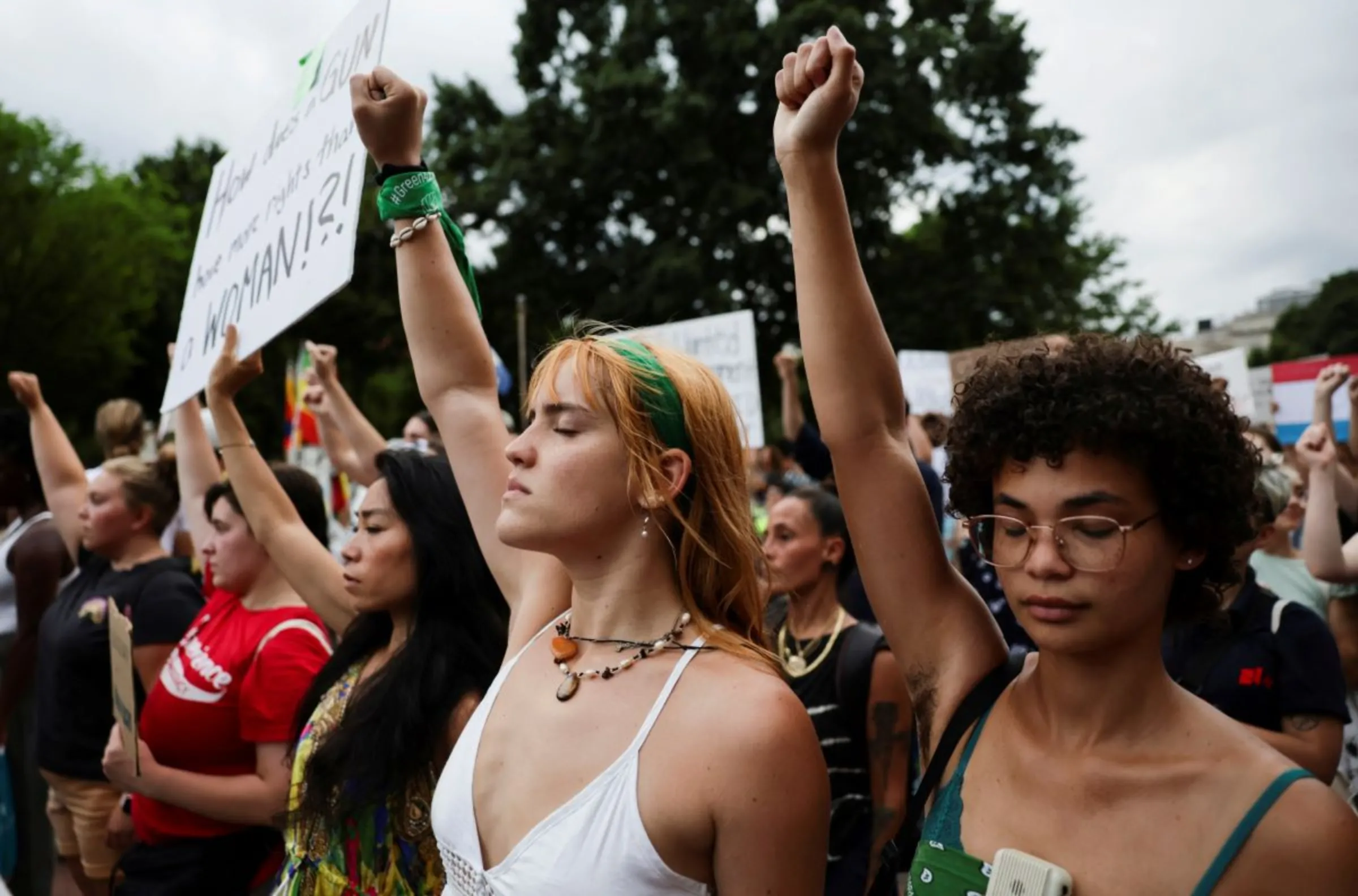 Abortion rights supporters raise their fists during a moment of silence as they protest after the United States Supreme Court ruled in the Dobbs v Women's Health Organization abortion case, overturning the landmark Roe v Wade abortion decision, in Washington, U.S., June 26, 2022