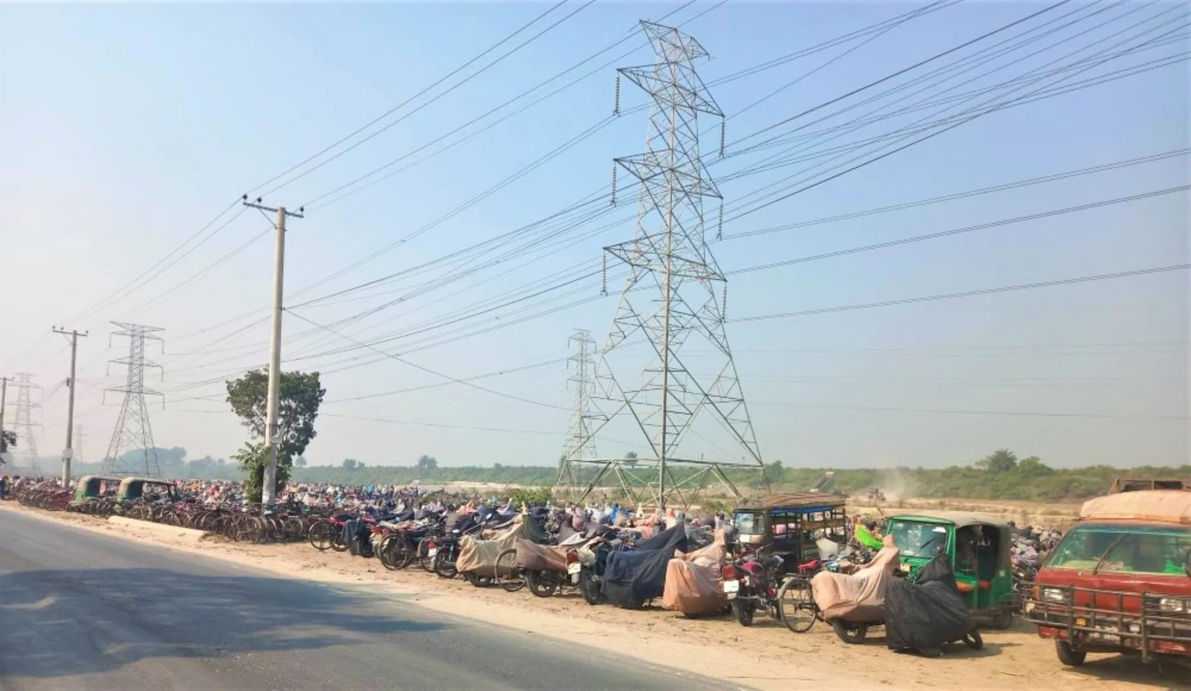 Motorcycles and cycles of workers employed at building the Rooppur plant are stacked in rows before the construction site, Bangladesh, 15 December 2022