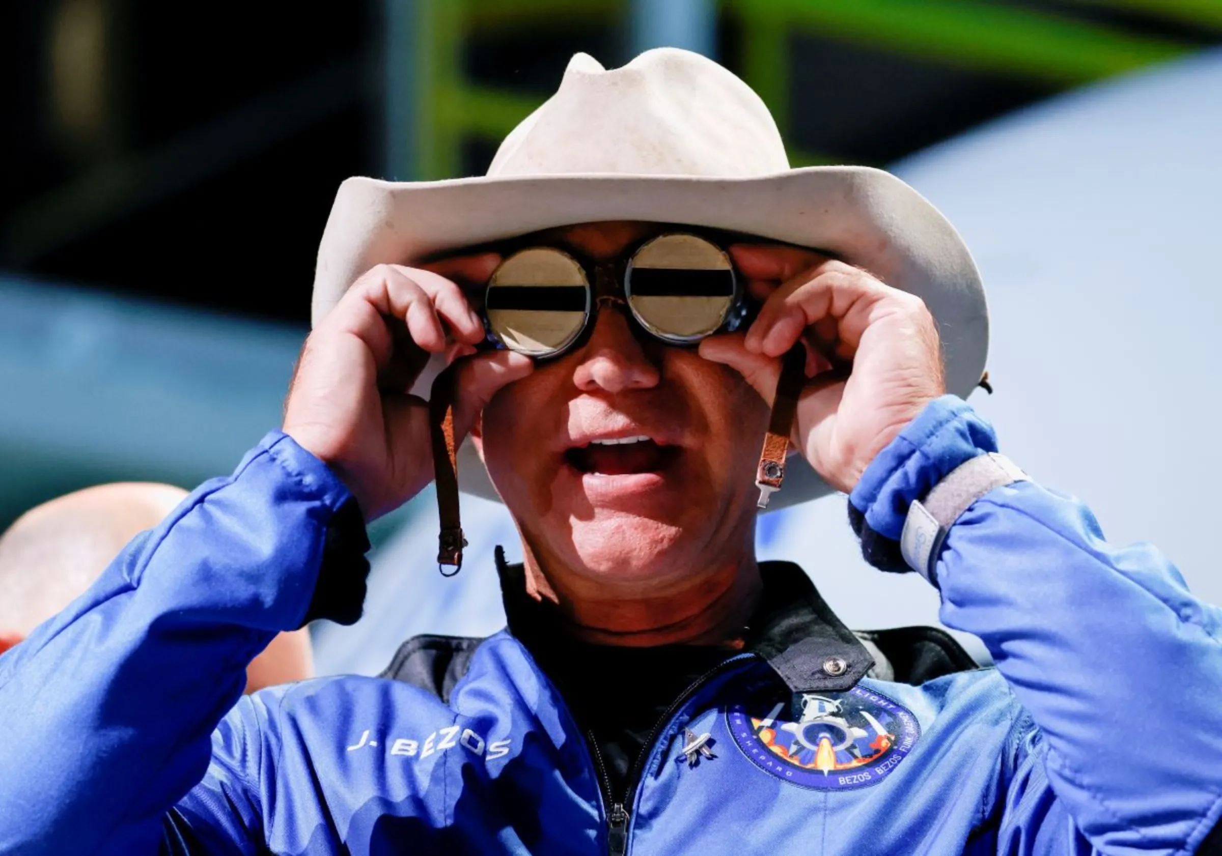 Billionaire American businessman Jeff Bezos poses with goggles owned by aviation pioneer Amelia Earhart which he wore on a flight to the edge of space, July 20, 2021, REUTERS/Joe Skipper