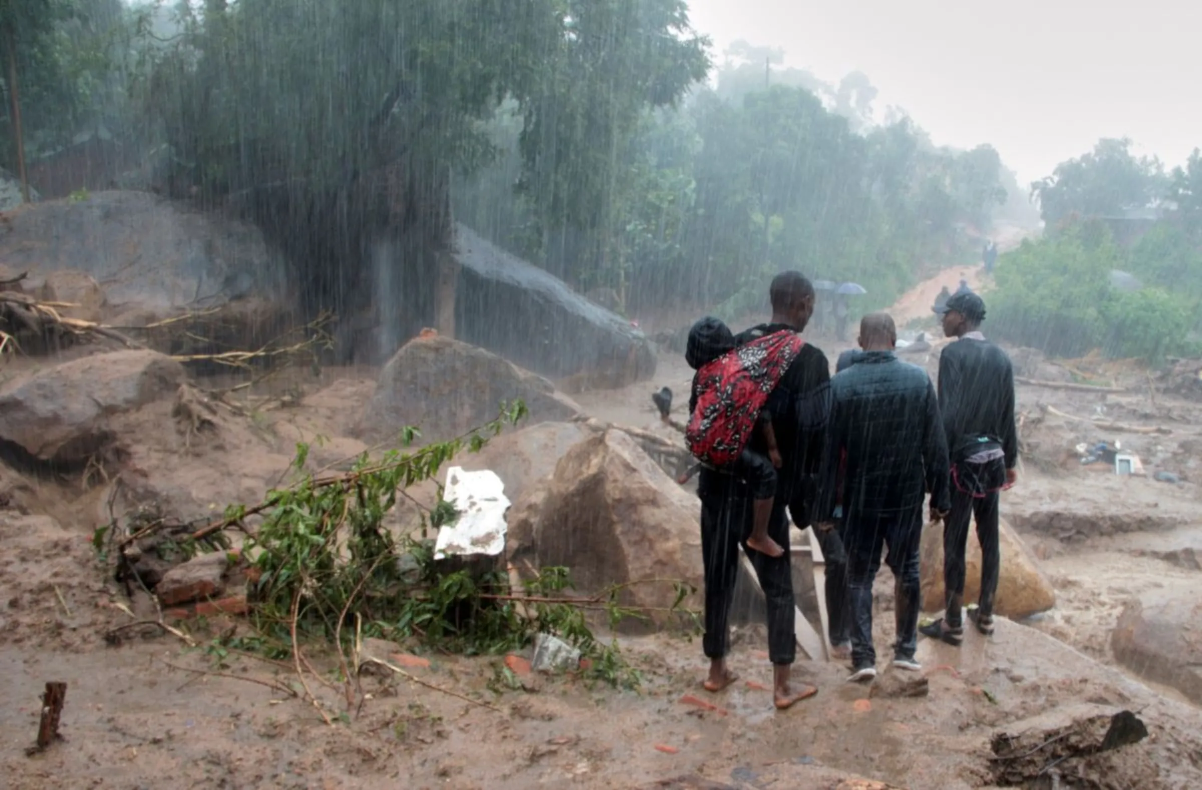 People look at the damage caused by Cyclone Freddy in Chilobwe, Blantyre, Malawi, March 13, 2023. REUTERS/Eldson Chagara.