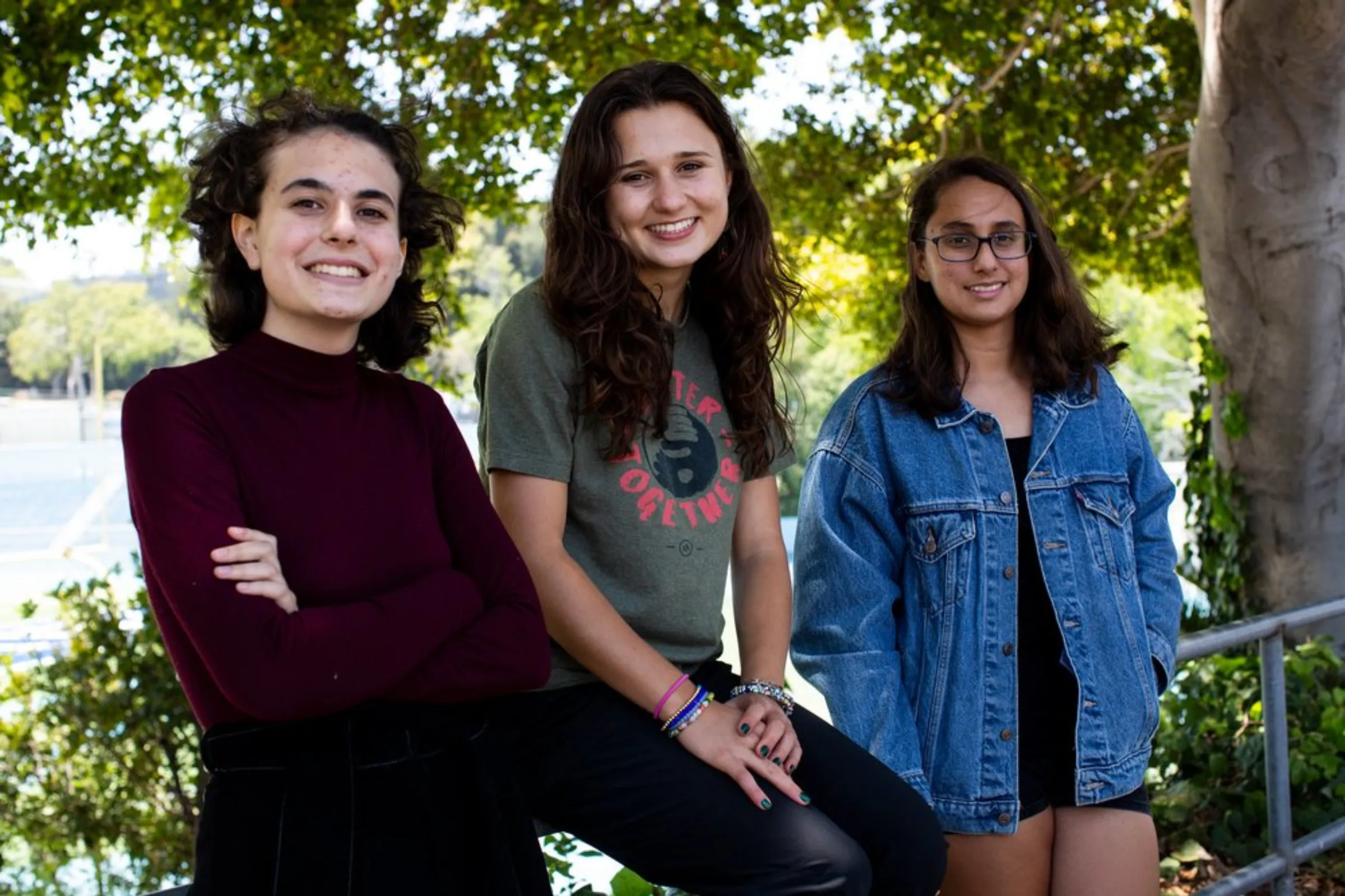 Young climate change activists Madison Liberman (L), Isabel Gill (C) and Nathalia Wyss (R) pose in front of Palisades High School in Los Angeles, California, June 3, 2021