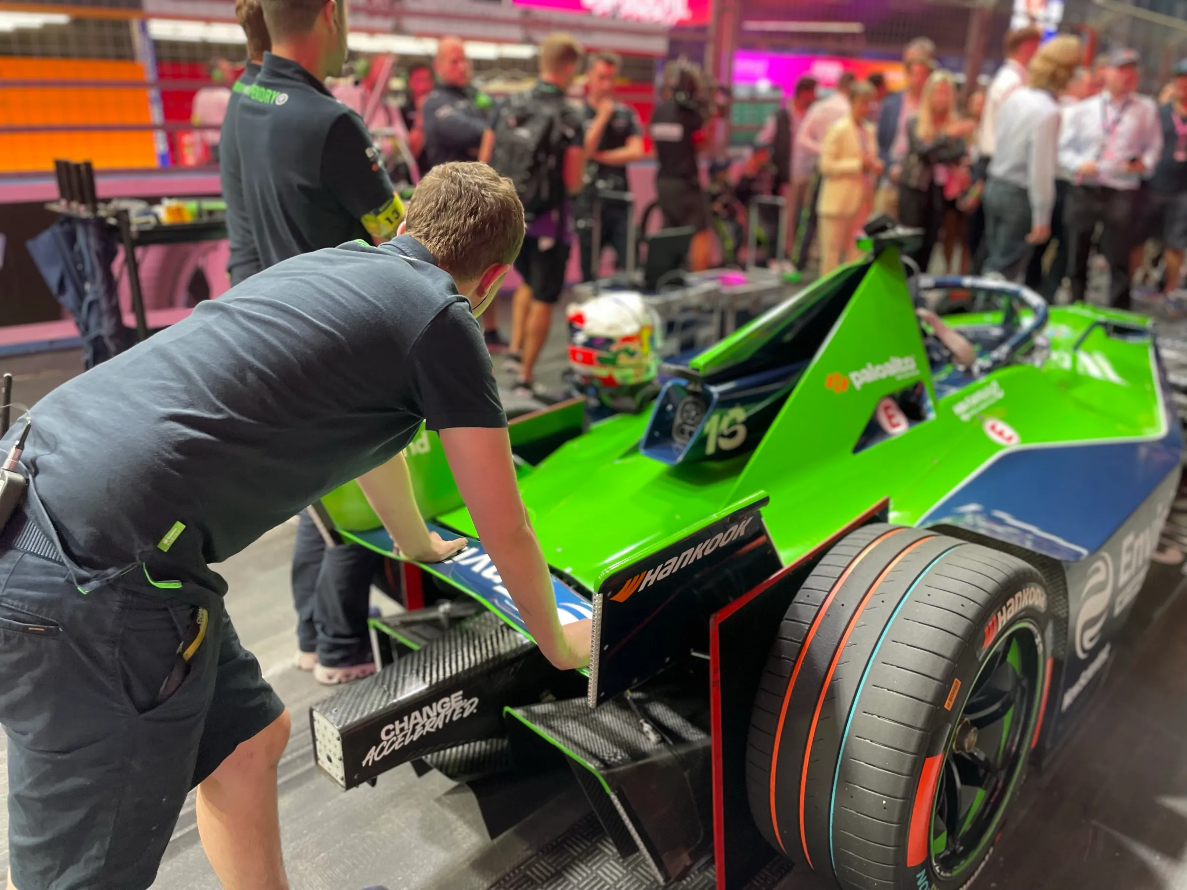 A member of the Envision racing Formula E team leans on the back of the Jaguar I-Type 6 race car before round 15 of the Formula E world championship at the ExCeL Centre in London, July 20, 2024.
