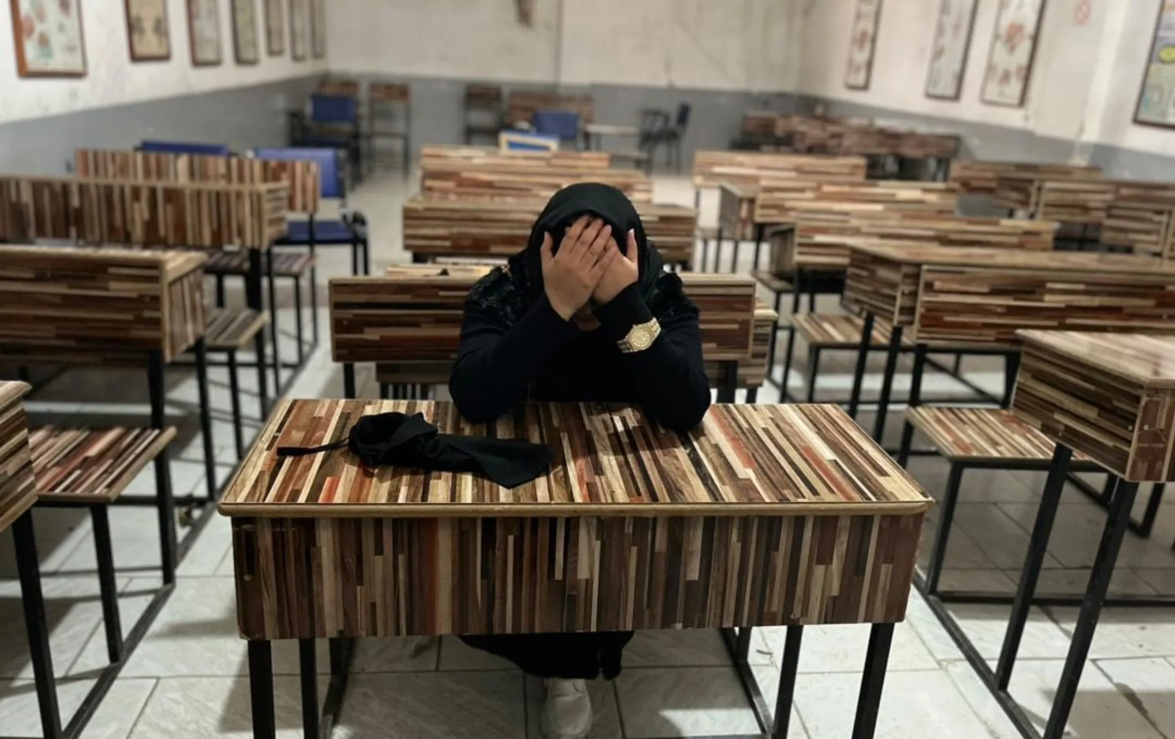 Maary Mohibian sits in an empty classroom at a nursing and midwifery institute in Mazar-i-Sharif after the Taliban shut it down on Dec 2, 2025. Handout via Thomson Reuters Foundation