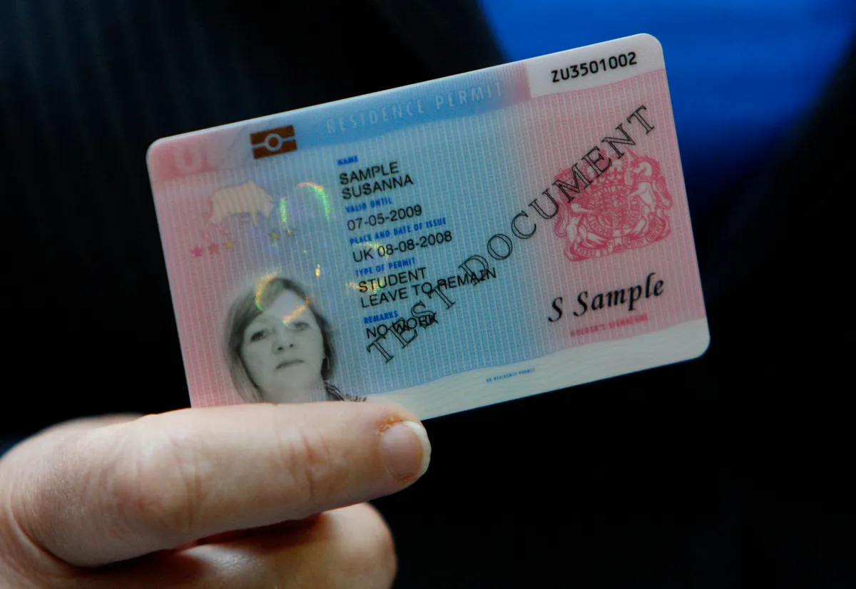 Britain's Home Secretary Jacqui Smith holds a sample British identity card at a news conference in London September 25, 2008.