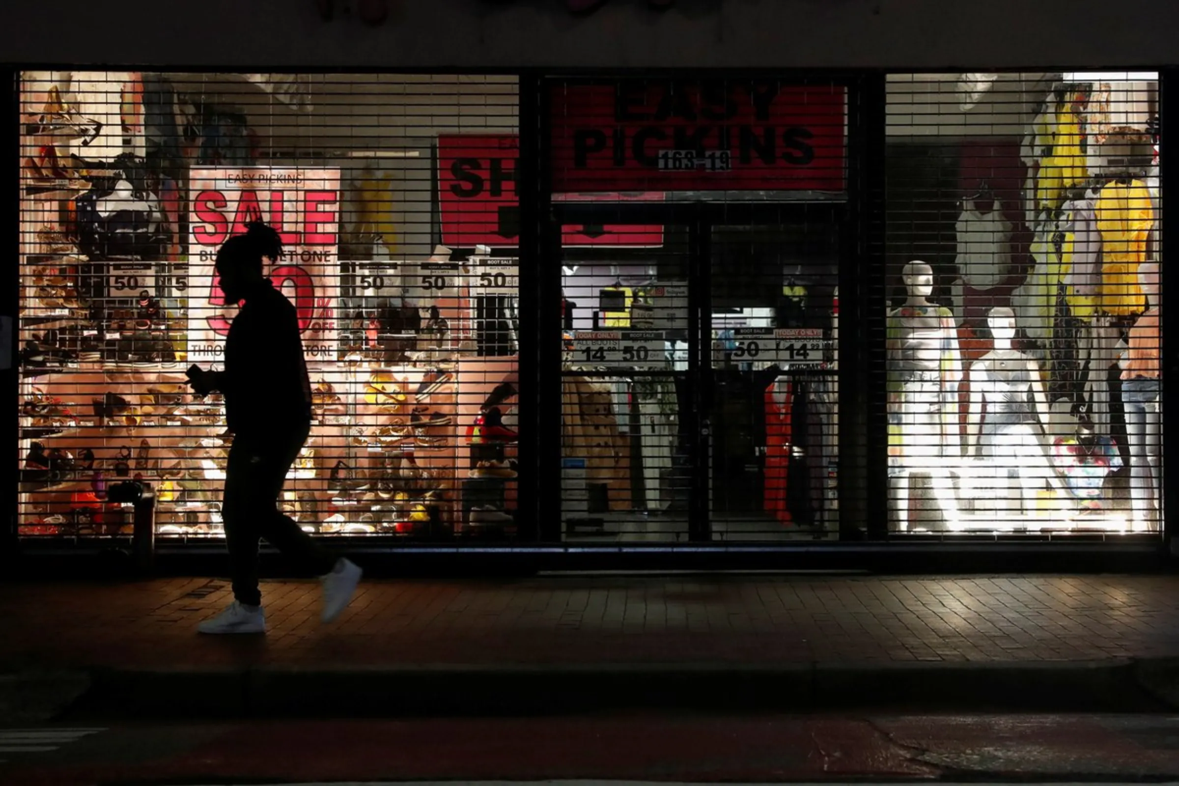 A man walks by a closed store as the coronavirus disease (COVID-19) continues, in the Queens borough of New York, U.S., May 10, 2020