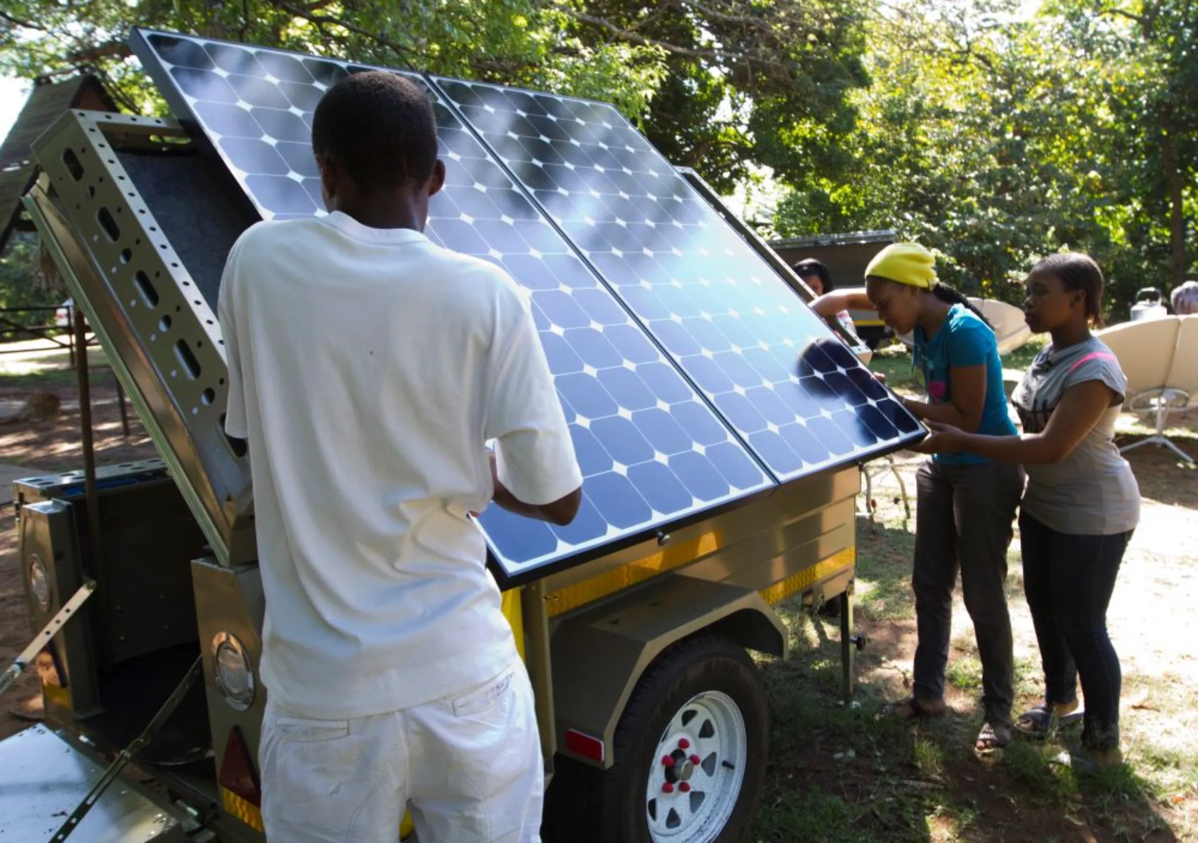 Scouts participate in a Greenpeace workshop, learning about renewable energy and are preparing two trailers equipped with solar panels and a wind turbine in Durban, October 4, 2011