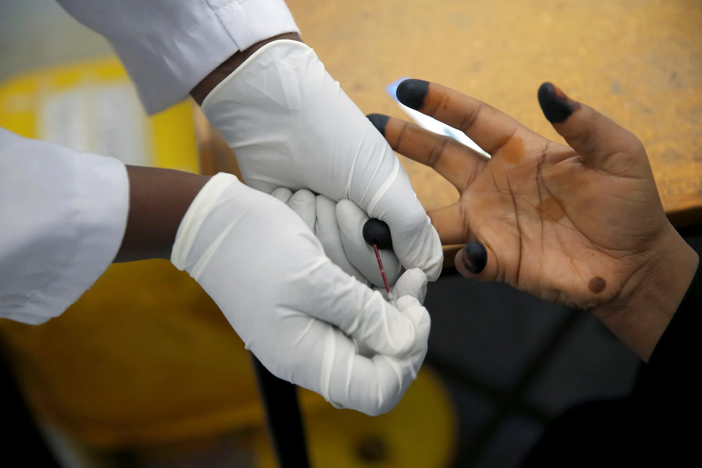 An HIV adherence counsellor draws a woman's blood for an HIV test at the IOM treatment centre in Eastleigh, Nairobi, Kenya, November 29, 2018. REUTERS/Baz Ratner