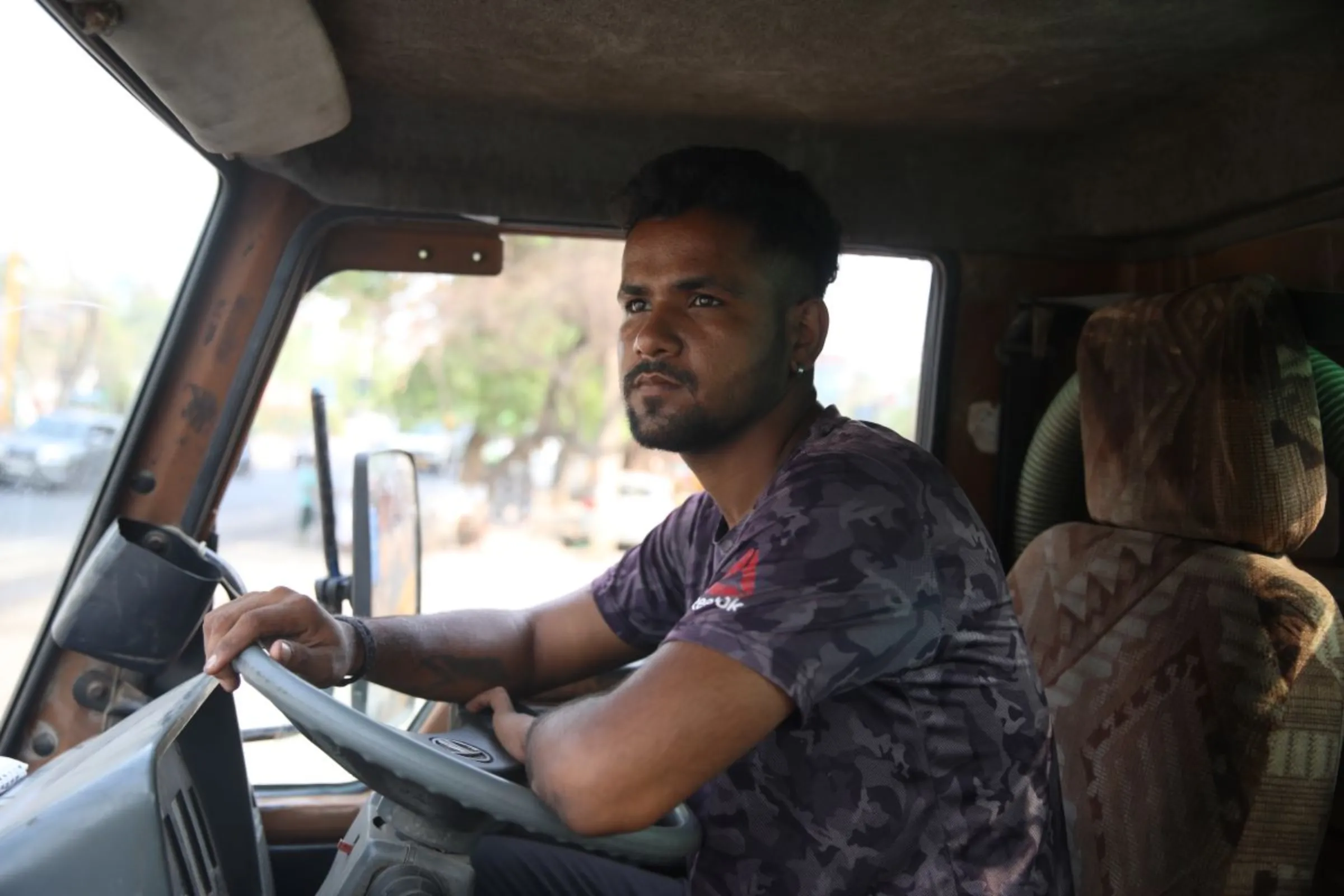 Narendra Singh, a water tanker driver, drives his truck to deliver water at low-income neighbourhoods in Delhi, India, June, 23, 2024. Thomson Reuters Foundation/Prabhat Mehrotra