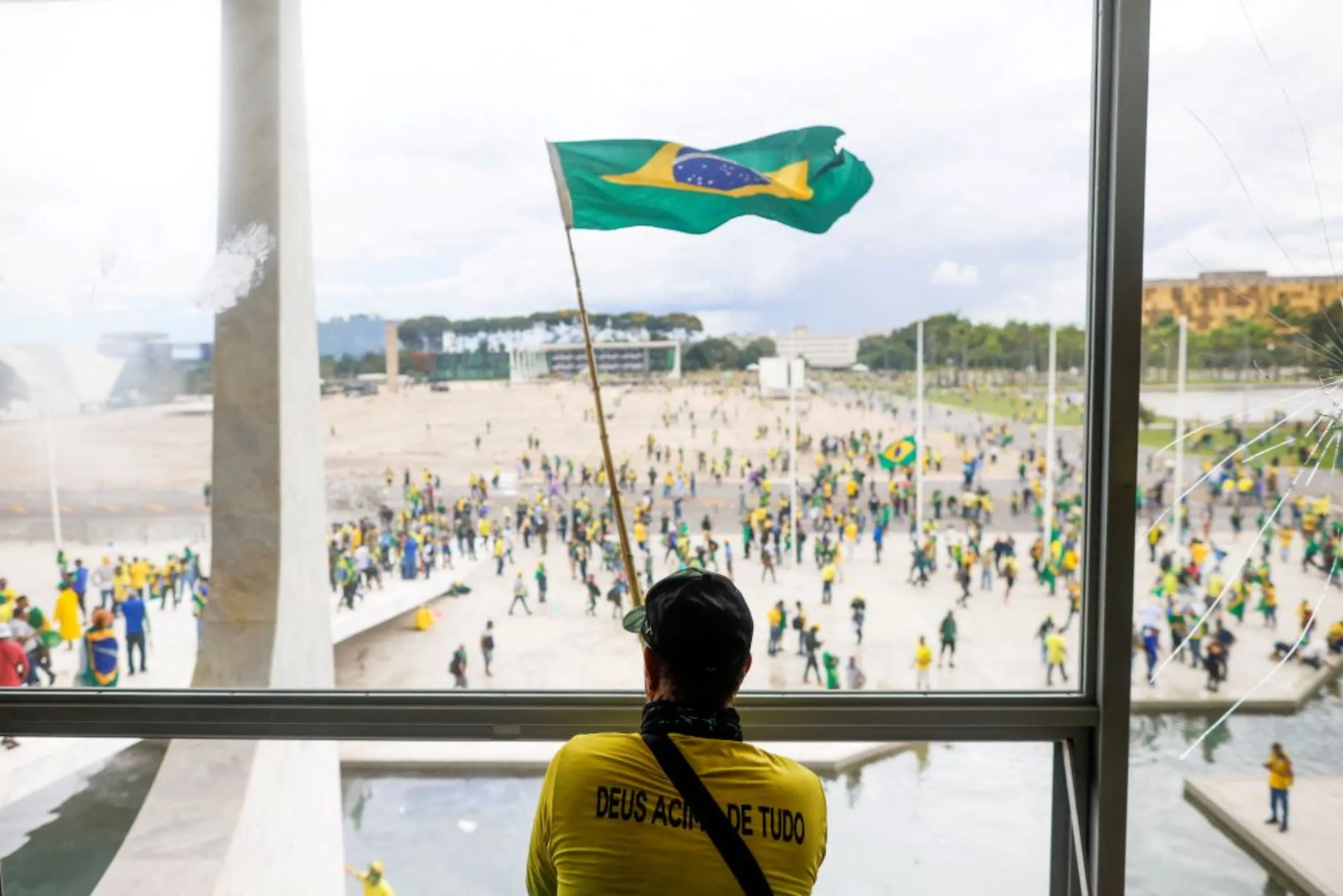 A man waves Brazil's flag as supporters of Brazil's former President Jair Bolsonaro demonstrate against President Luiz Inacio Lula da Silva, outside Brazil's National Congress in Brasilia, Brazil, January 8, 2023
