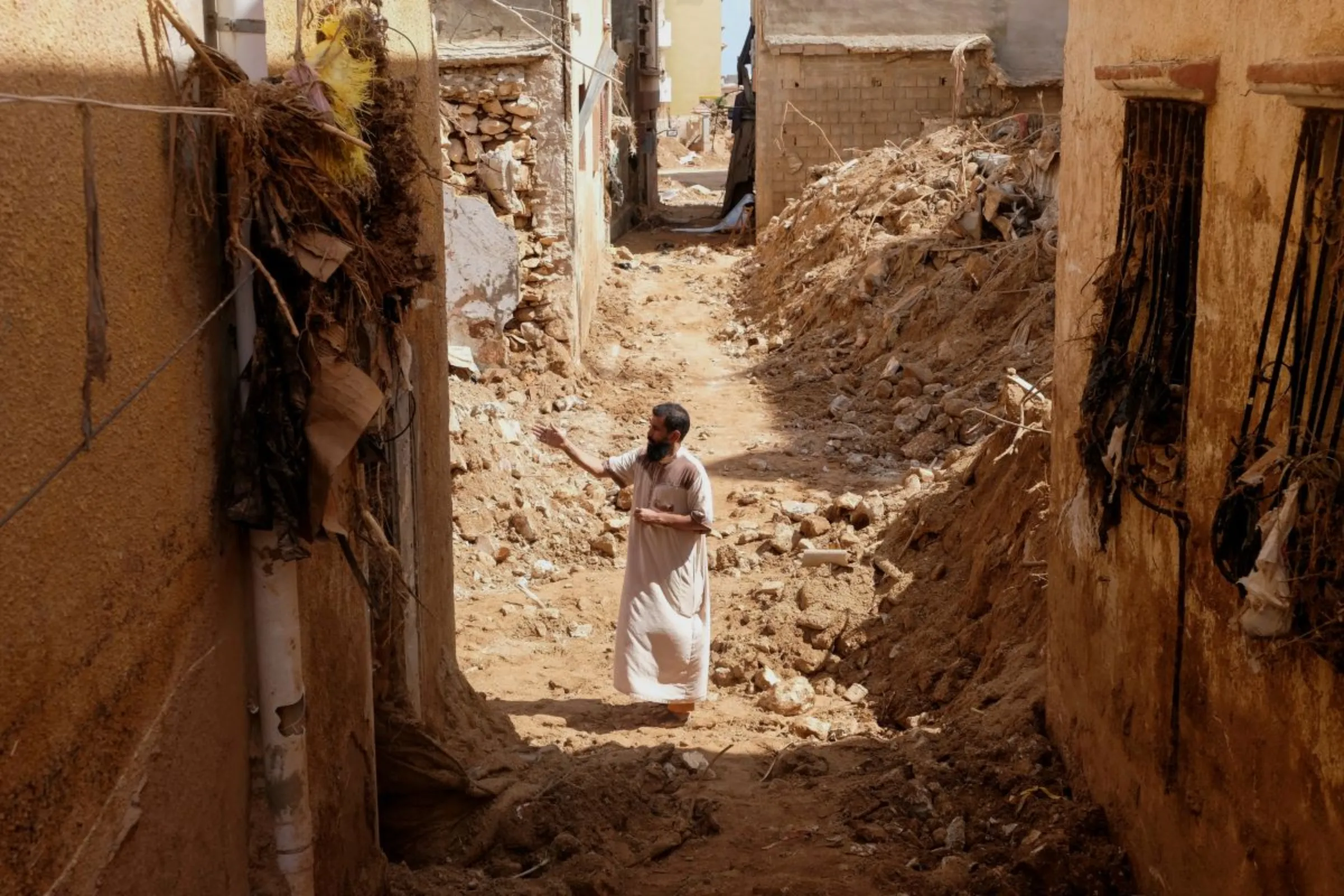A man inspects damaged buildings, in the aftermath of a deadly storm and flooding that hit Libya, in Derna, Libya September 20, 2023