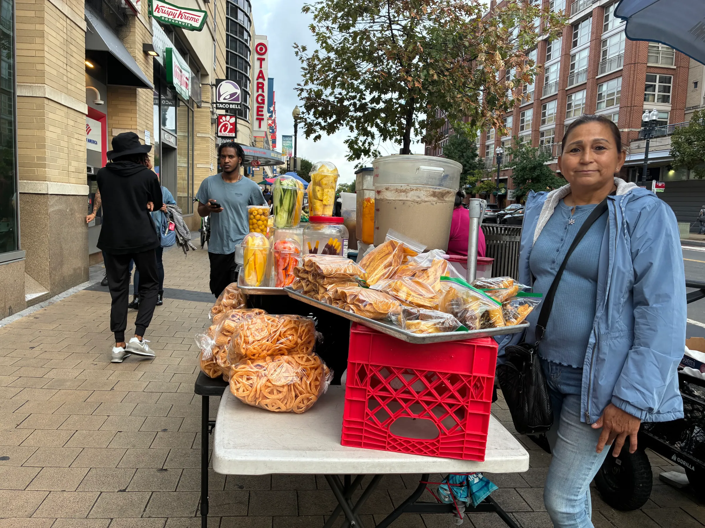 Street vendor Gloria Gomez with her goods in Washington, United States on Oct. 8, 2025. Thomson Reuters Foundation/Carey L. Biron
