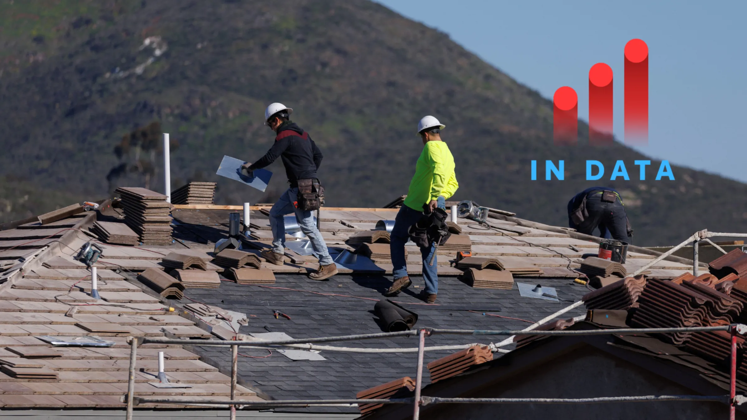 Construction workers tile a roof, as a subdivision of homes is built in San Marcos, California, U.S., January 31, 2023. REUTERS/Mike Blake