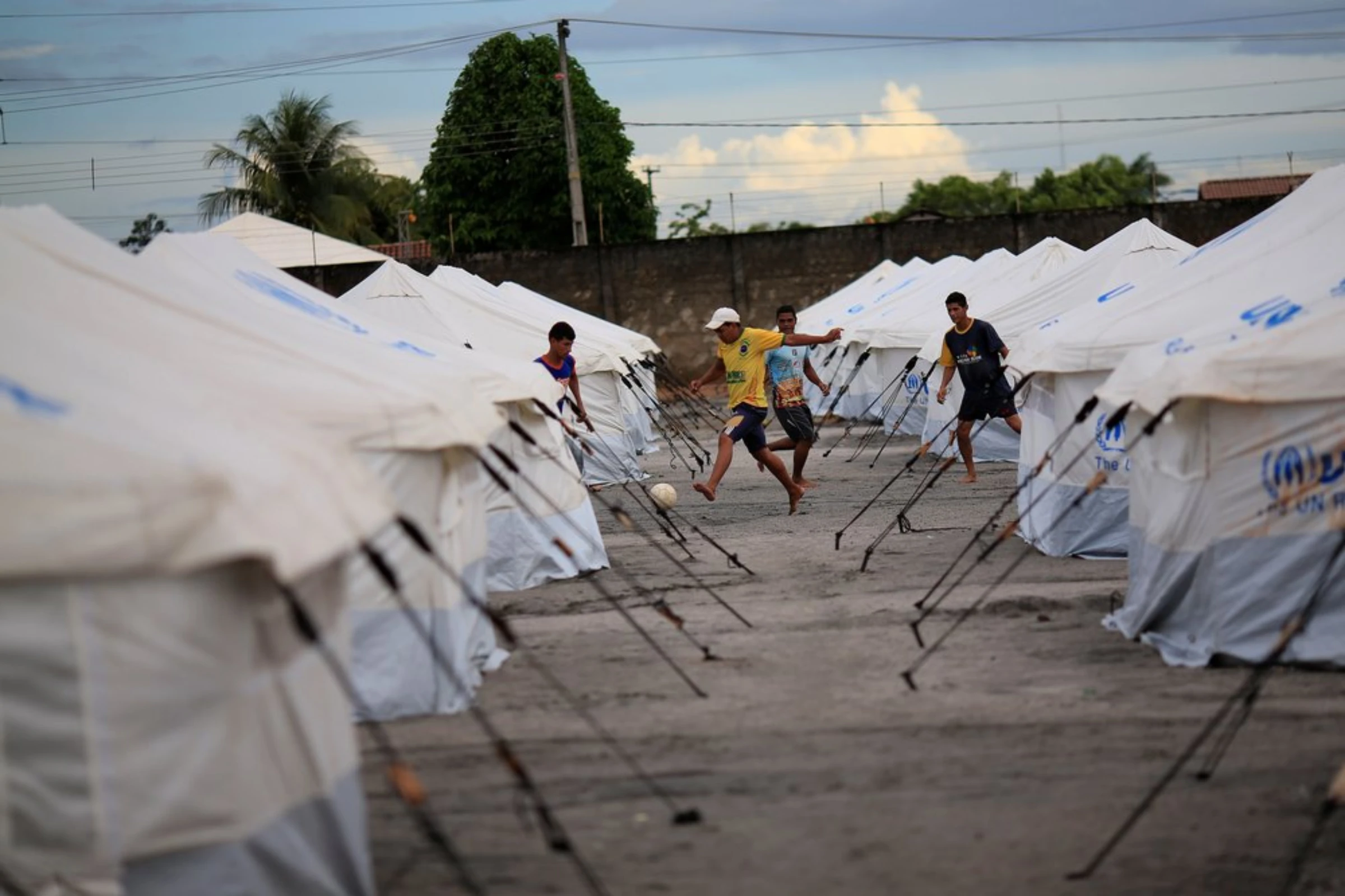 Venezuelan migrants play soccer between the tents in a UNHCR shelter in Boa Vista, Brazil May 3, 2018