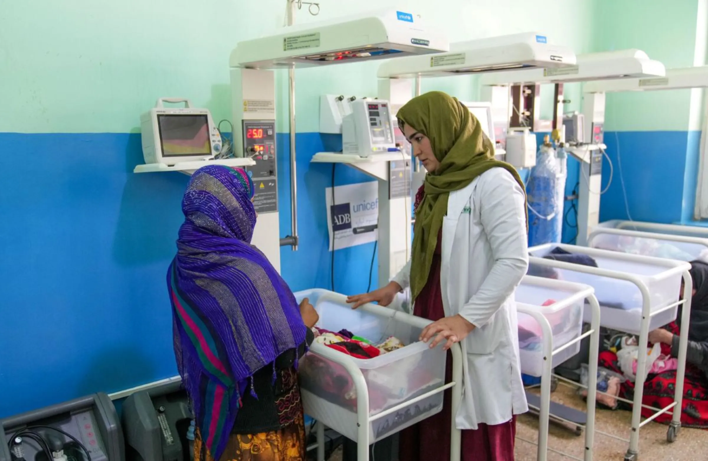 A nurse checks a new-born with sepsis in the neonatal ward at Badghis provincial hospital on February 27, 2023