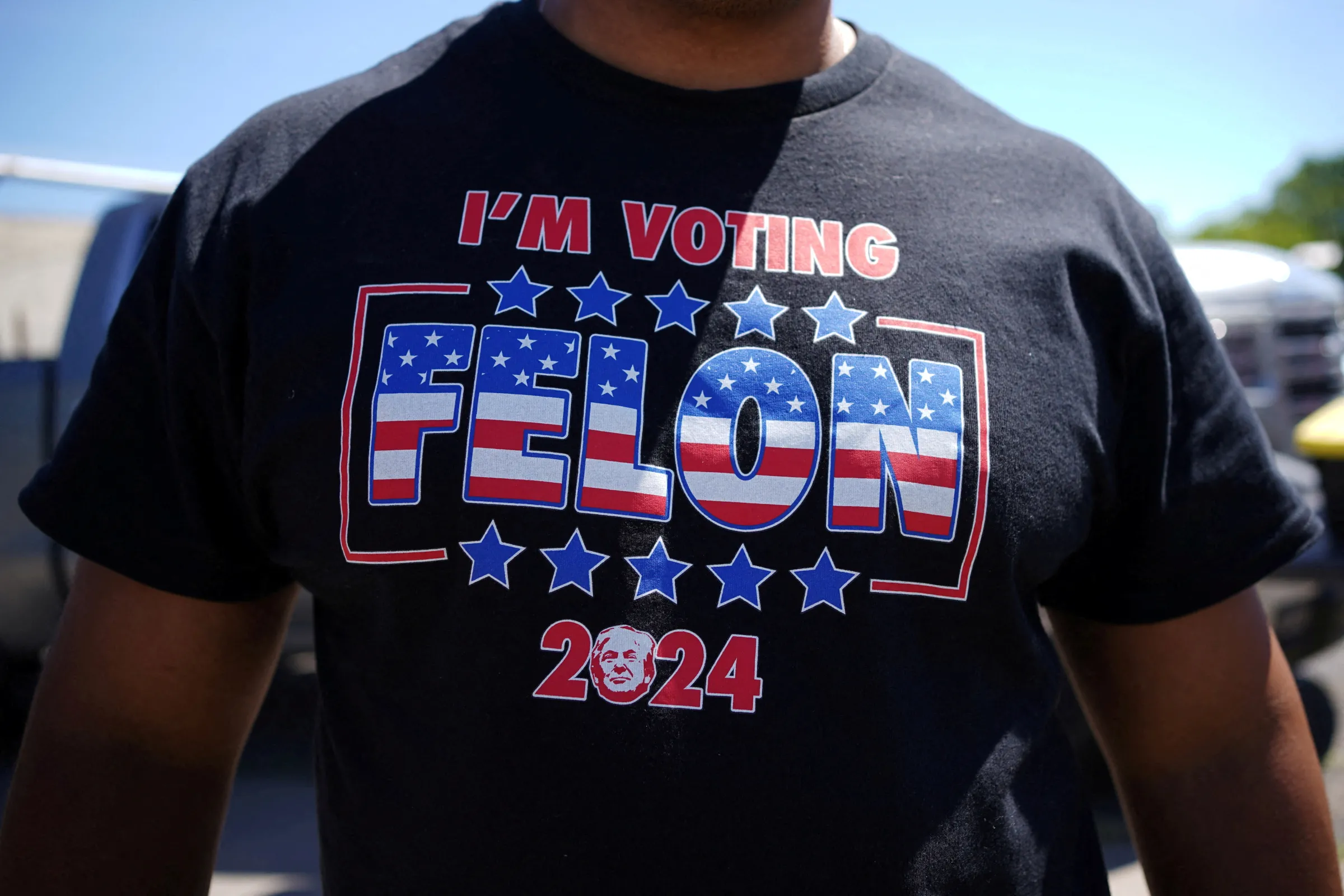 A supporter wears a t-shirt reading 'I'm Voting Felon' before a campaign community roundtable with Republican presidential candidate and former U.S. President Donald Trump at 180 Church in Detroit, Michigan, U.S., June 15, 2024. REUTERS/Brian Snyder