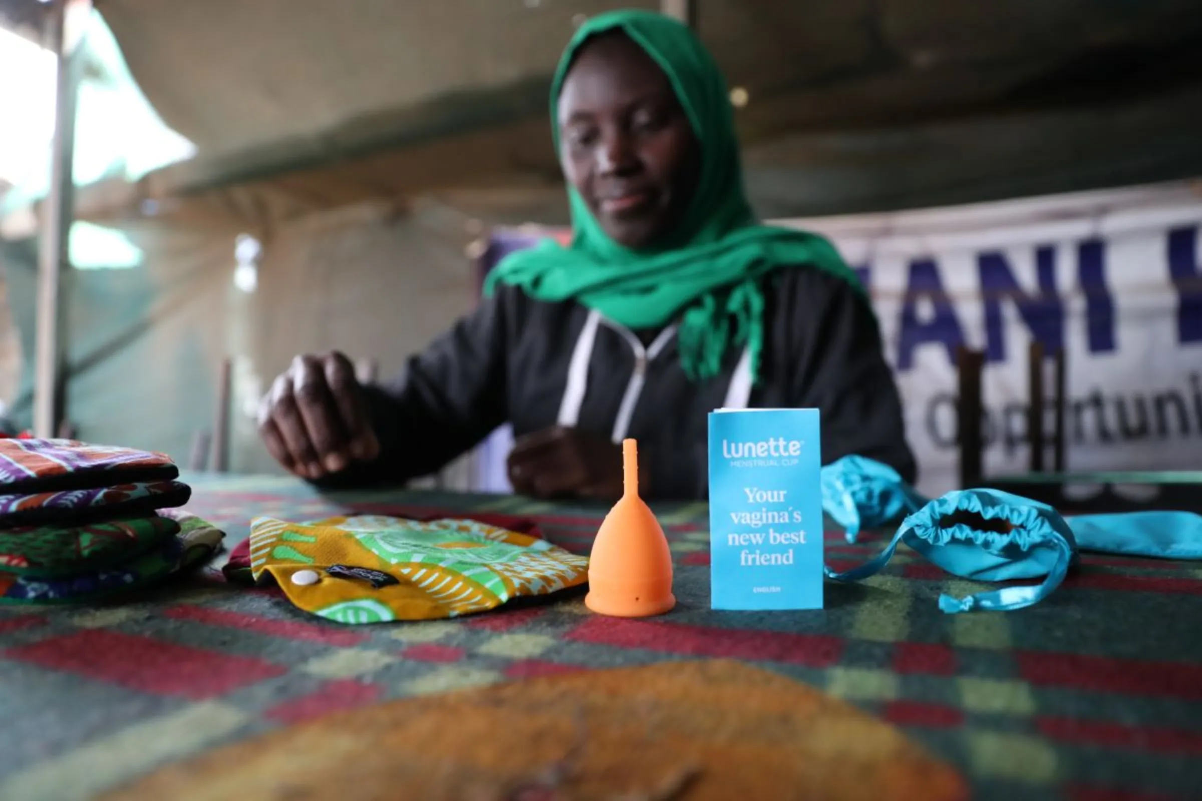 Mariam Twahir, co-founder of charity Amani Kibera shows the reusable pads and menstrual cup being distributed to girls in Kibera informal settlement in Nairobi, Kenya on April 15, 2023