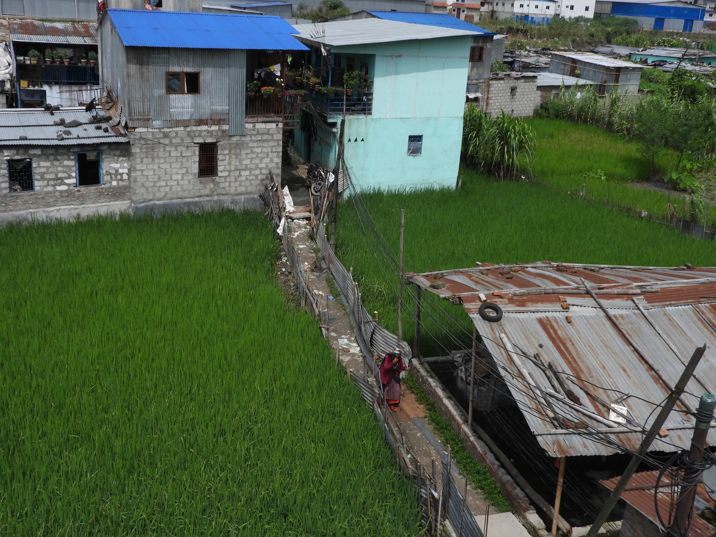 An elderly woman walks in a slum on the outskirts of Kathmandu, Nepal, September 8, 2022