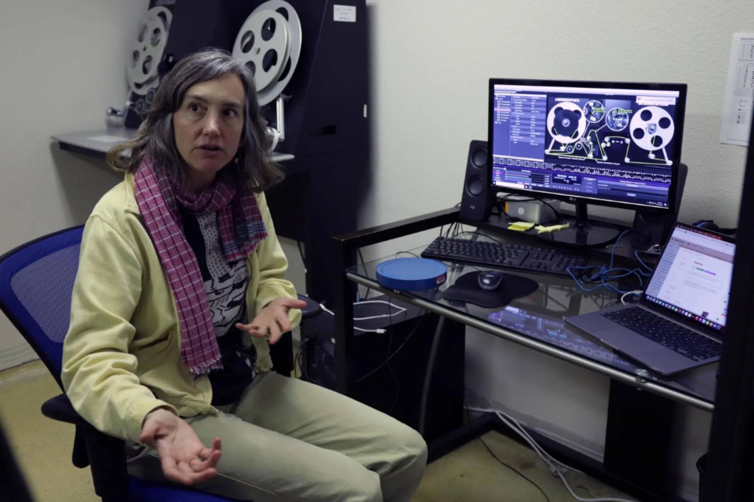 An archivist demonstrates film digitization and preservation at the Internet Archive’s physical archive in Richmond, California, in October 2023. Brad Shirakawa/Handout via Thomson Reuters Foundation